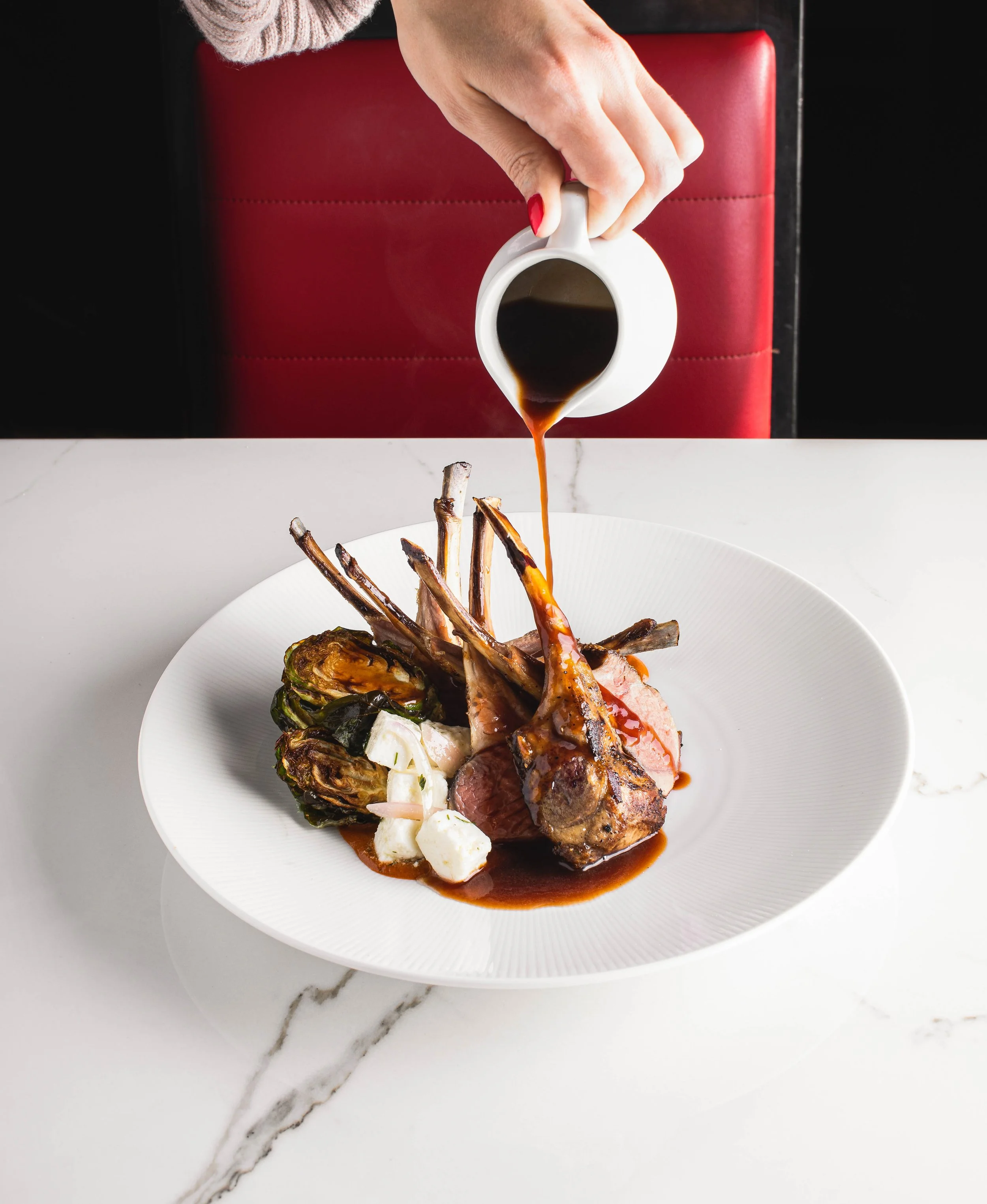 Hand pouring sauce over rack of lamb for S.N.O.B. Charleston, SC.

Studio Lou is a food, restaurant, interior, and lifestyle photographer based out of Charleston, South Carolina and servicing clients in Savannah Georgia, Columbia South Carolina, Myrt