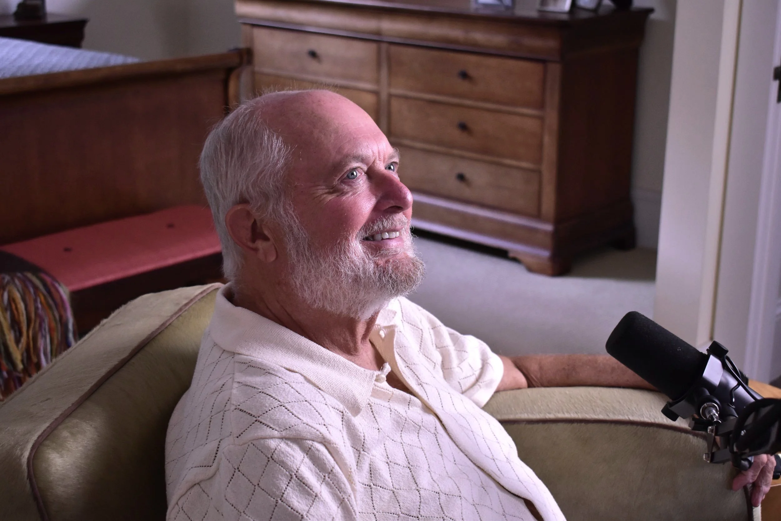 An elderly gentleman behind a microphone sharing his thoughts about working with sound legacy.