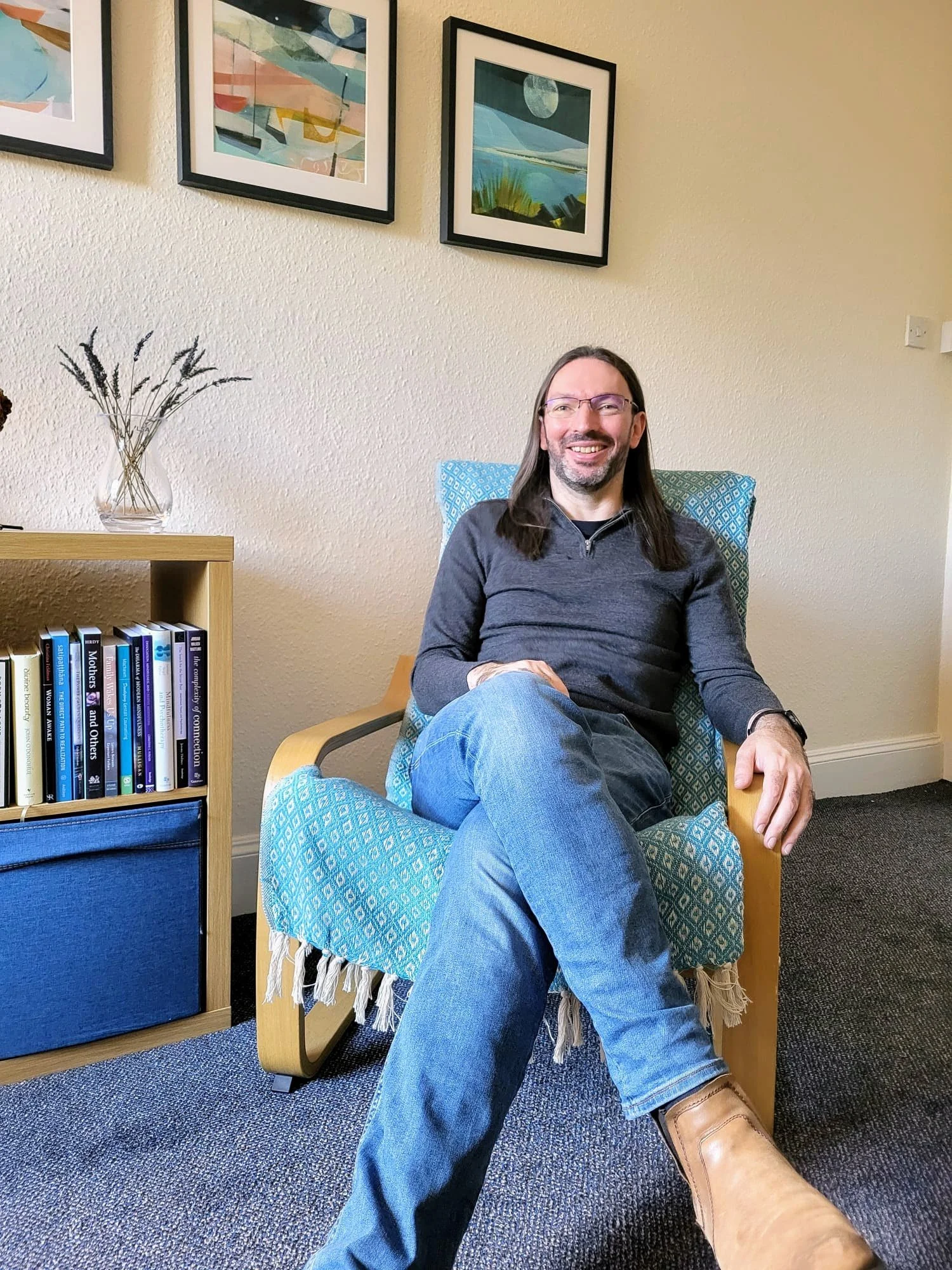 Sitting in my therapy room and smiling, mid-conversation.