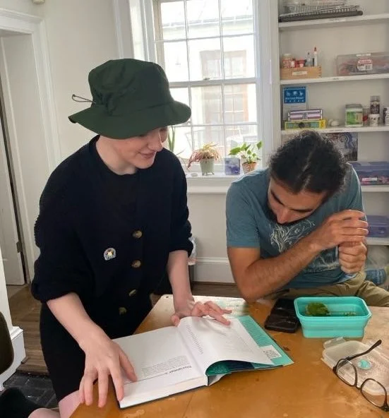 An adult mentor and a young person talking together in a warm, relaxed setting. The adult is listening and supporting without taking over, reflecting a non-directive, respectful mentoring relationship.