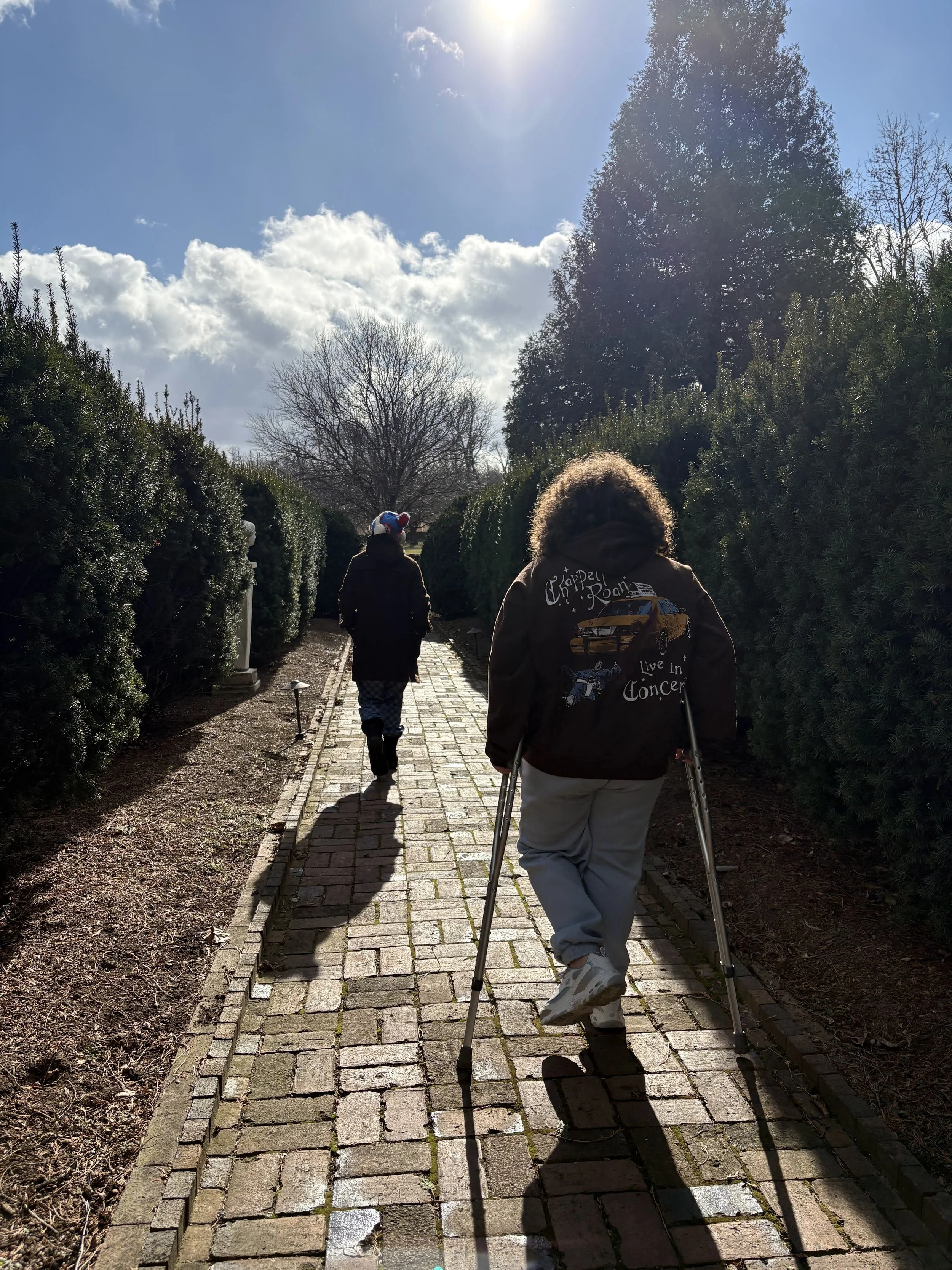 Two teens walking down a path.