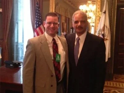 Washington, DC (2013) in the ceremonial office of the Vice President with US Attorney General Eric Holder following a meeting to discuss the Sandy Hook Elementary School Shooting and solutions to school gun violence. 