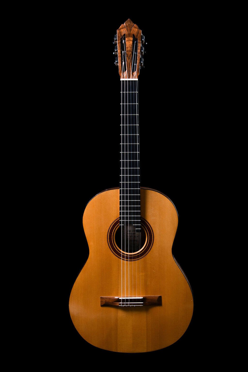 Front view of guitar with a French polish finish and hand-carved soundport