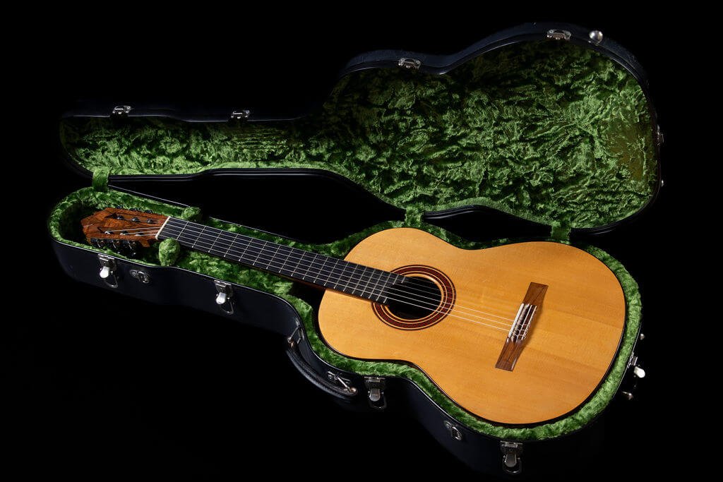 A guitar with a French polish finish in a Carlton flight case with green velvet lining