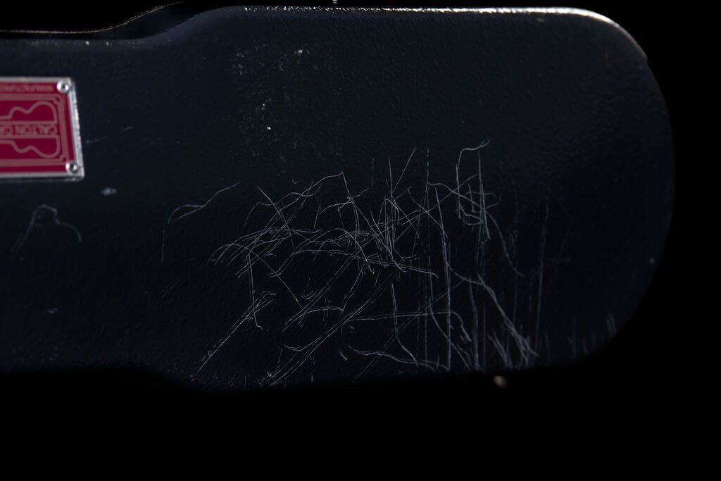 Closeup of scratches on the side of a black Carlton flight case