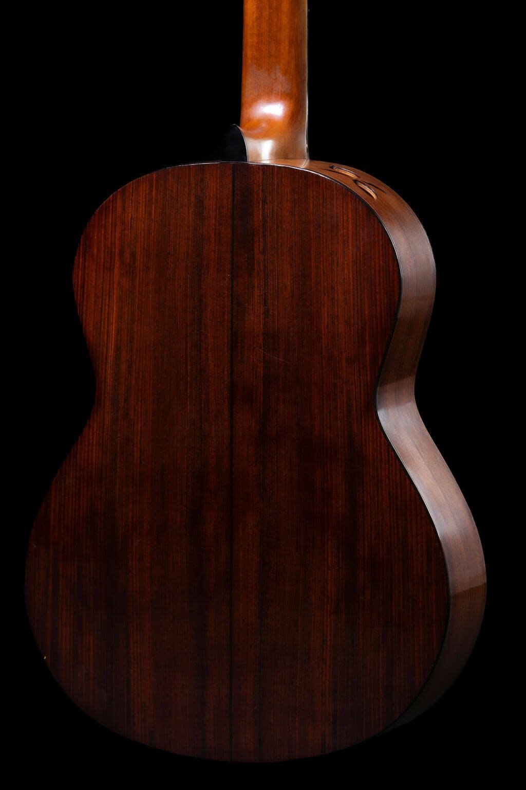 Closeup view of the back of a guitar with cocobolo back