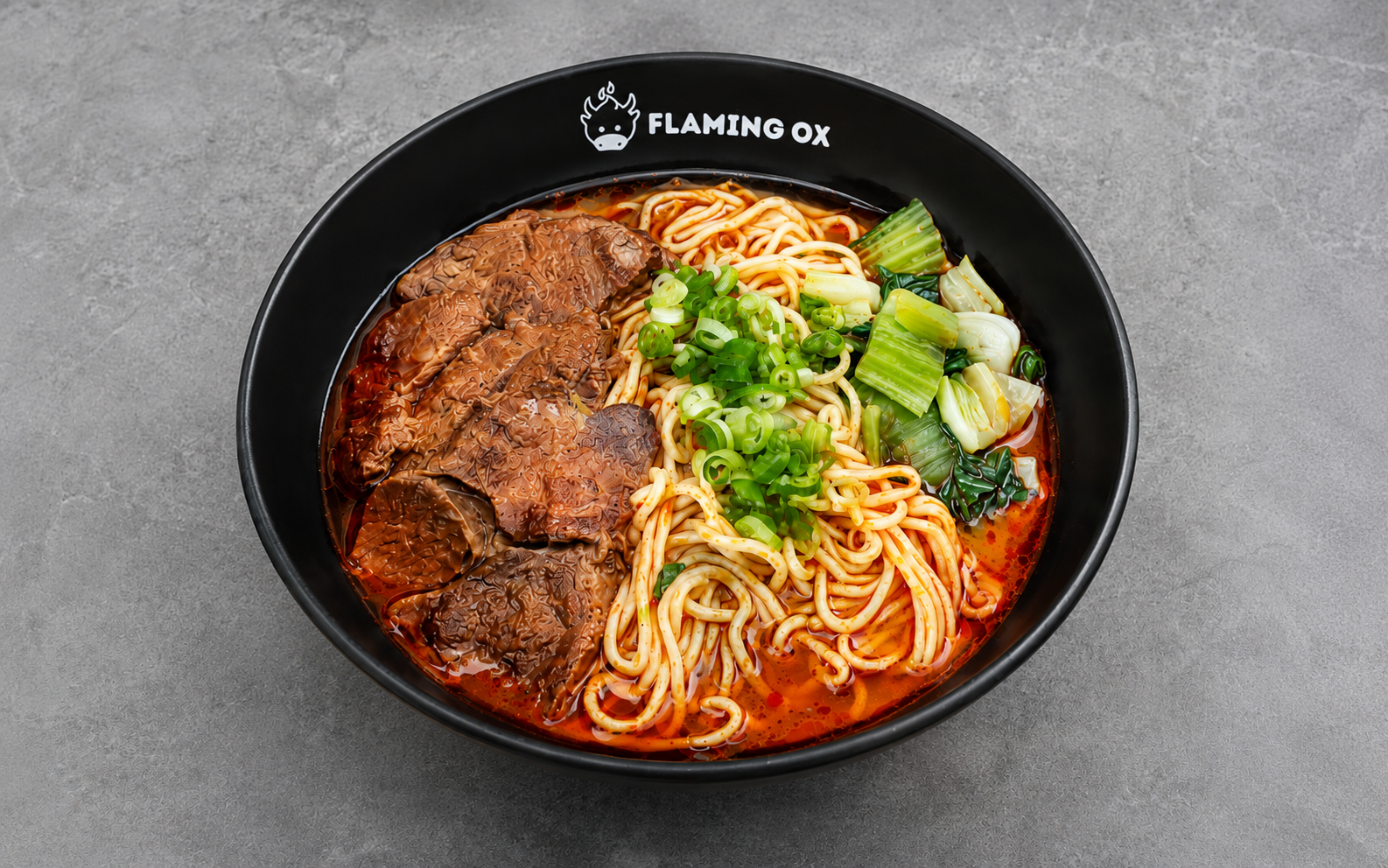 Mala Beef Noodle Soup with beef shank, noodles, bok choy, scallions, and spicy numbing mala broth at Flaming Ox in San Jose.