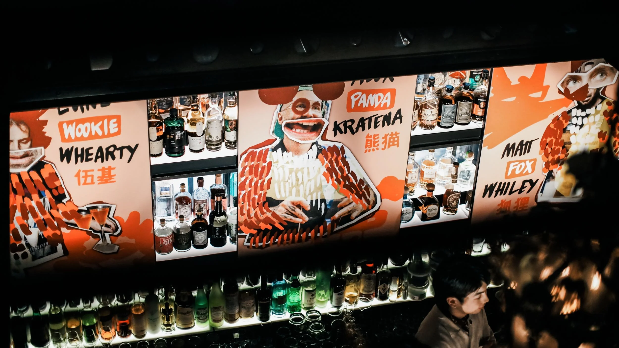 Bird’s eye photograph of Obsidian bar showing orange posters with collage-style images of Luke Whearty, Alex Kratena and Matt Whiley with their names hand-written beside their portrait.