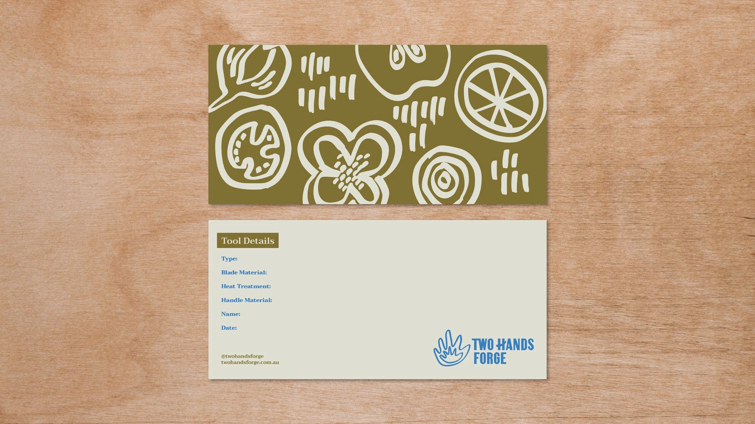 Front and back of Two Hands Forge “Tool Details” card sitting on a plywood background showing illustrations on one side and notes on reverse.