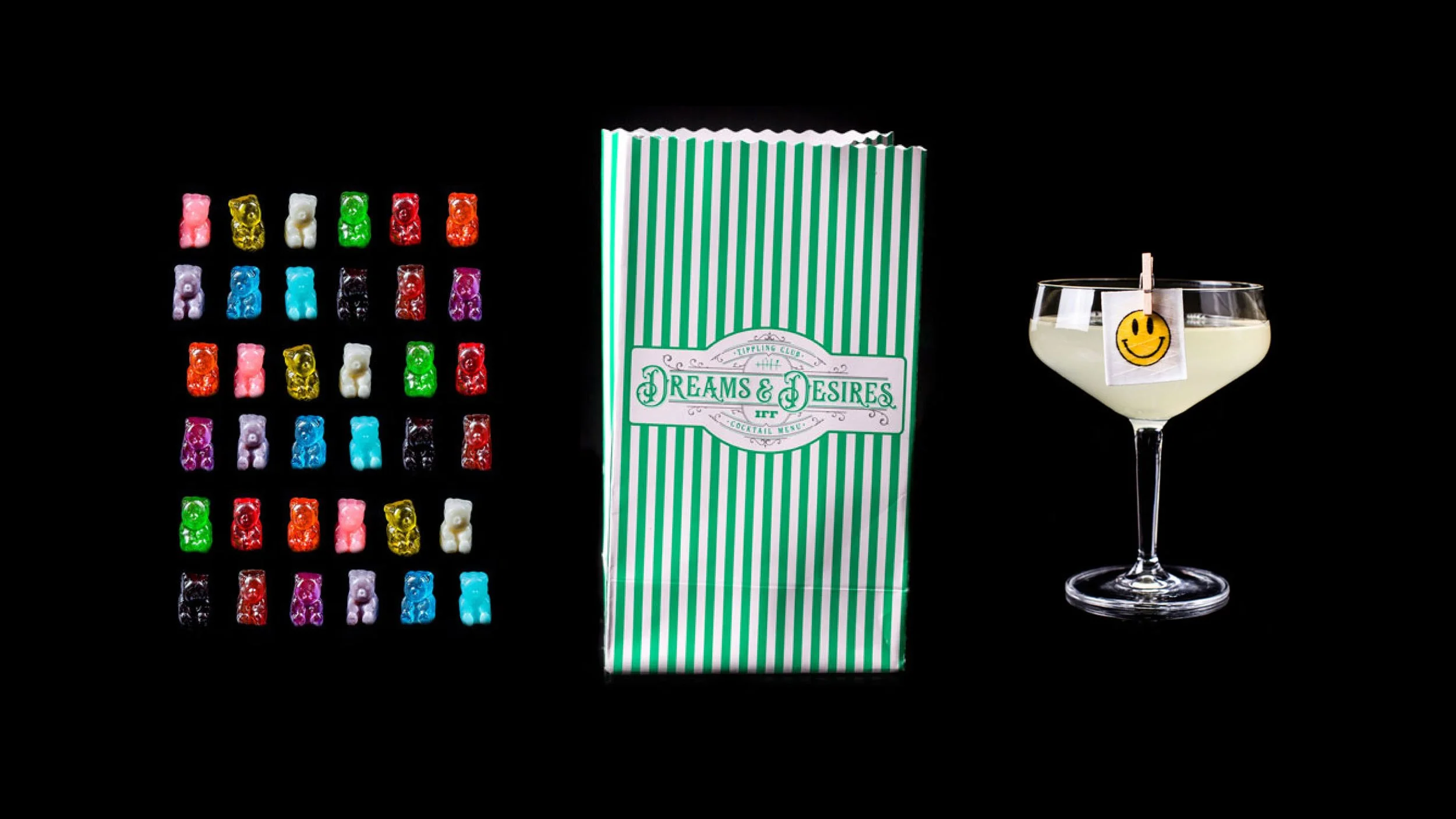Six by six grid of colourful gummy bears (left), green and white striped paper sweets bag with “Tippling Club IFF Dreams & Desires Cocktail Menu” on the front (centre) and cocktail with a smily face edible sticker pegged to the front (right).