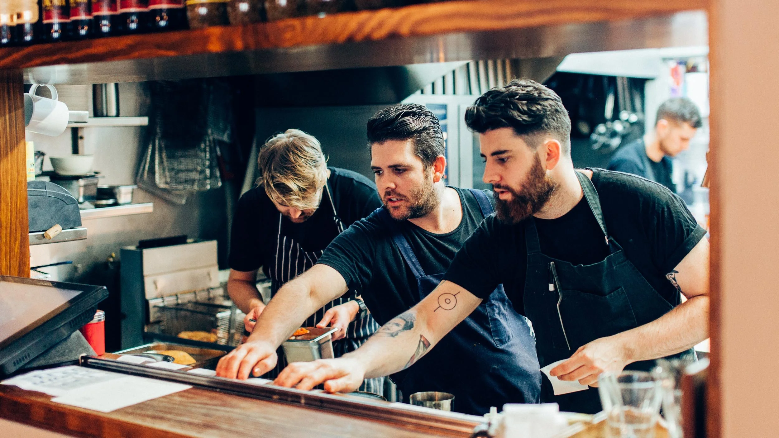 Terry Dempsey, Adam Wolfers and Pete Cooksley working in the kitchen at The Lincoln in Carlton.