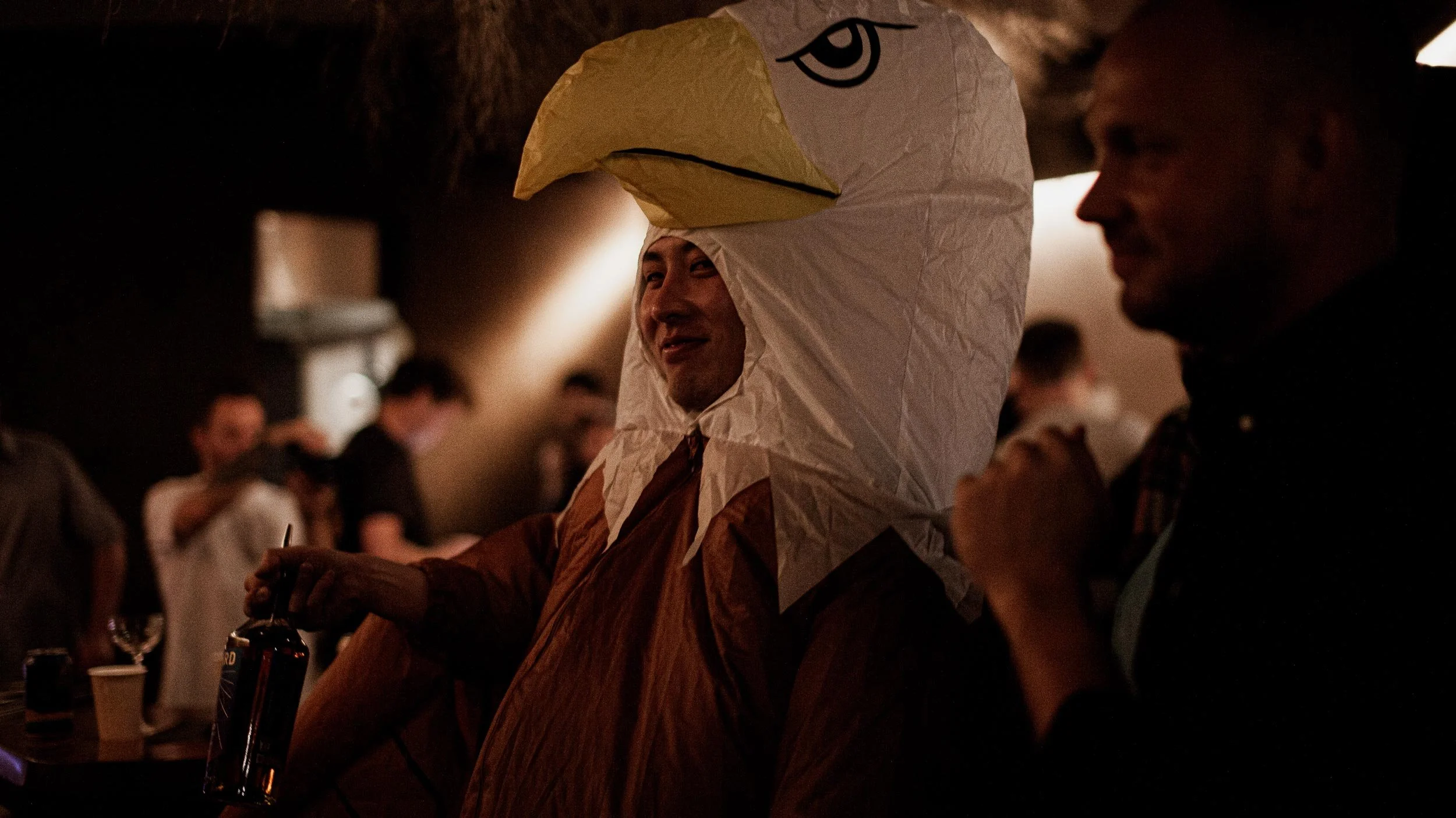 A person in an inflatable eagle costume smiles at the camera.