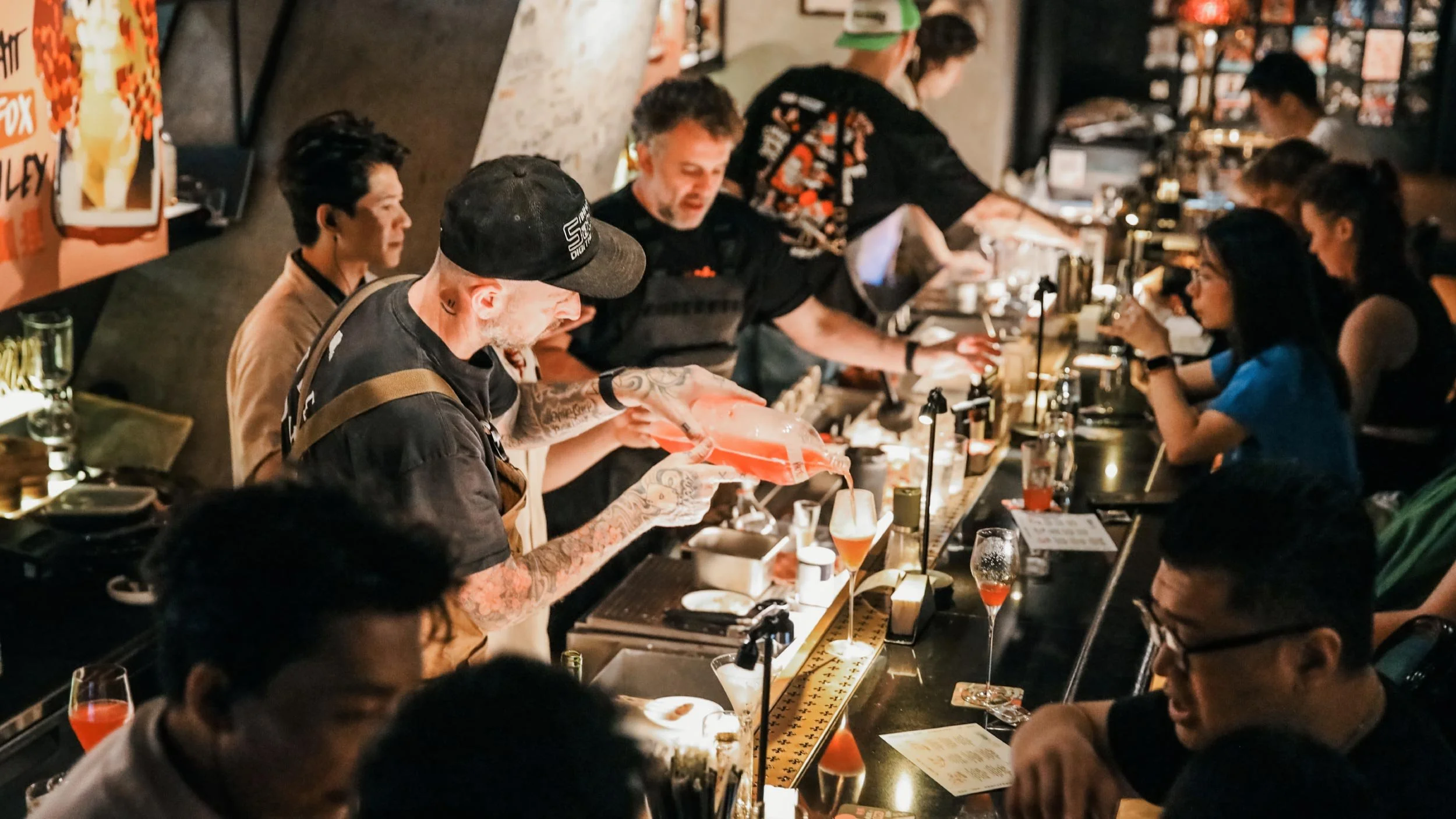 Matt Whiley, Luke Whearty and Alex Kratena working behind the bar at Obsidian. On the bar top, LMC menus and coasters can be seen.