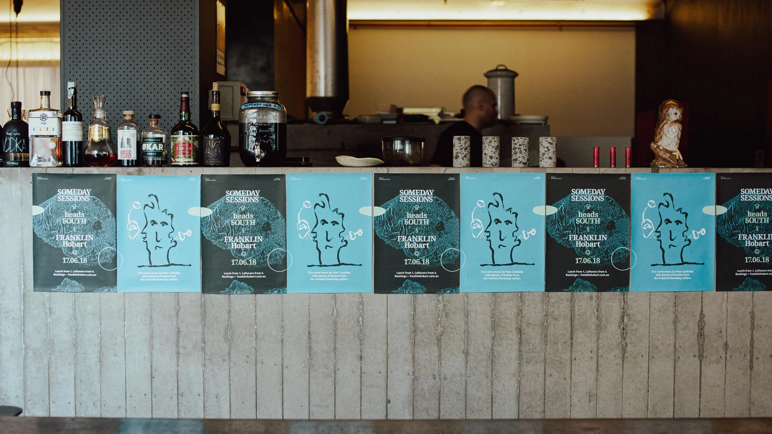 Series of Someday Sessions posters in Franklin, Hobart stuck up along the front of a concrete bar.