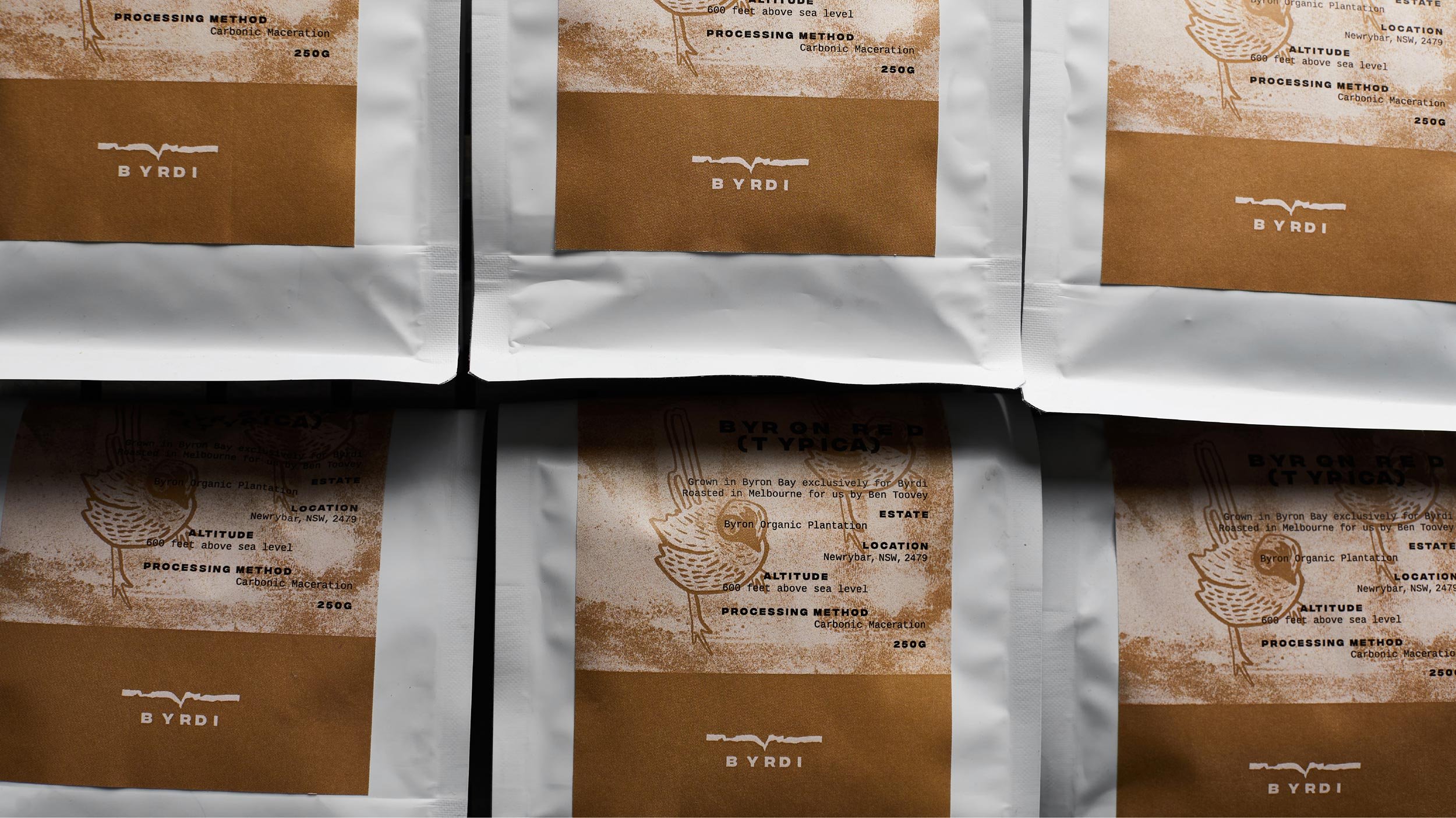 Closeup of Byrdi coffee packaging showing logo and bird printed in brown.