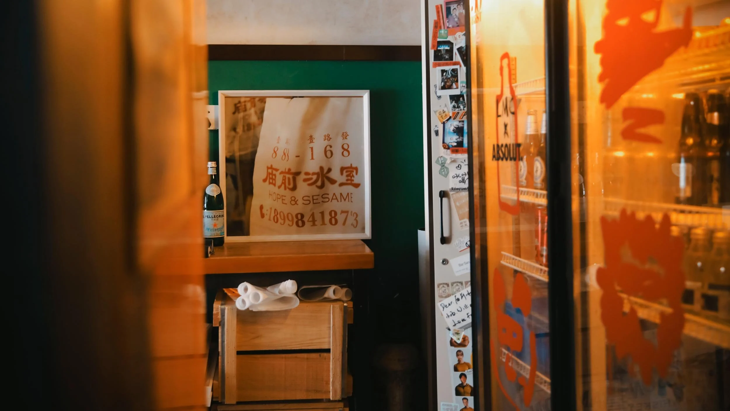 Interior waiting area of Hope & Sesame in Guangzhou, China featuring orange LMC decals on fridge doors in the foreground.
