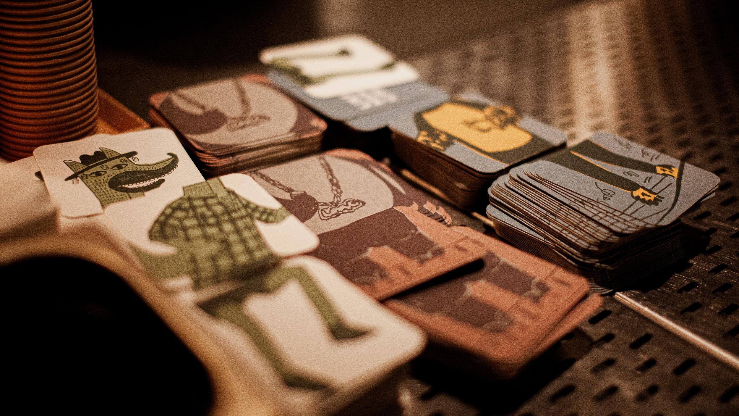 Piles of coasters on the Byrdi back bar showing segments of fox, panda and wookie that connect together to form an illustration of each.