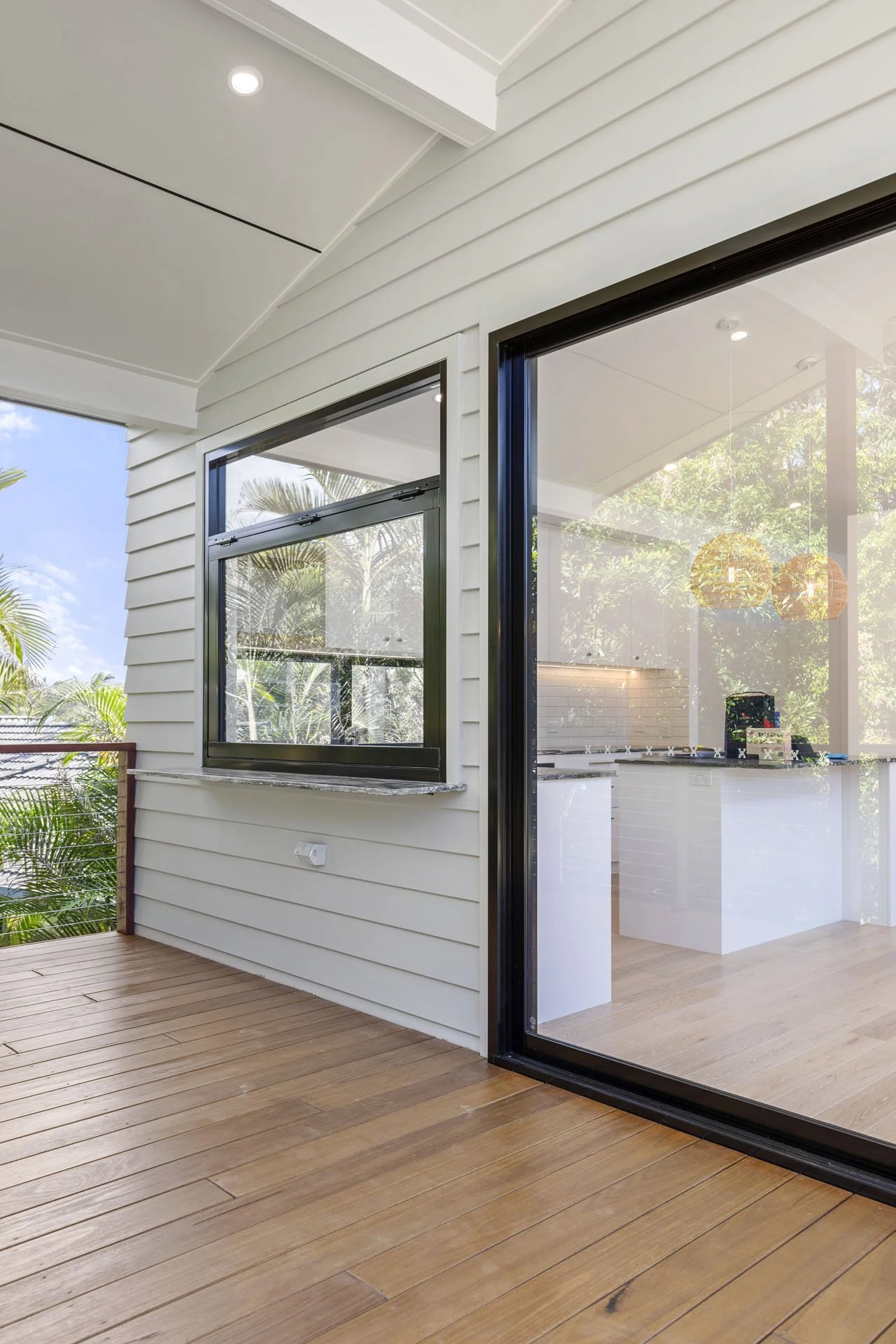 White weatherboard house with timber deck