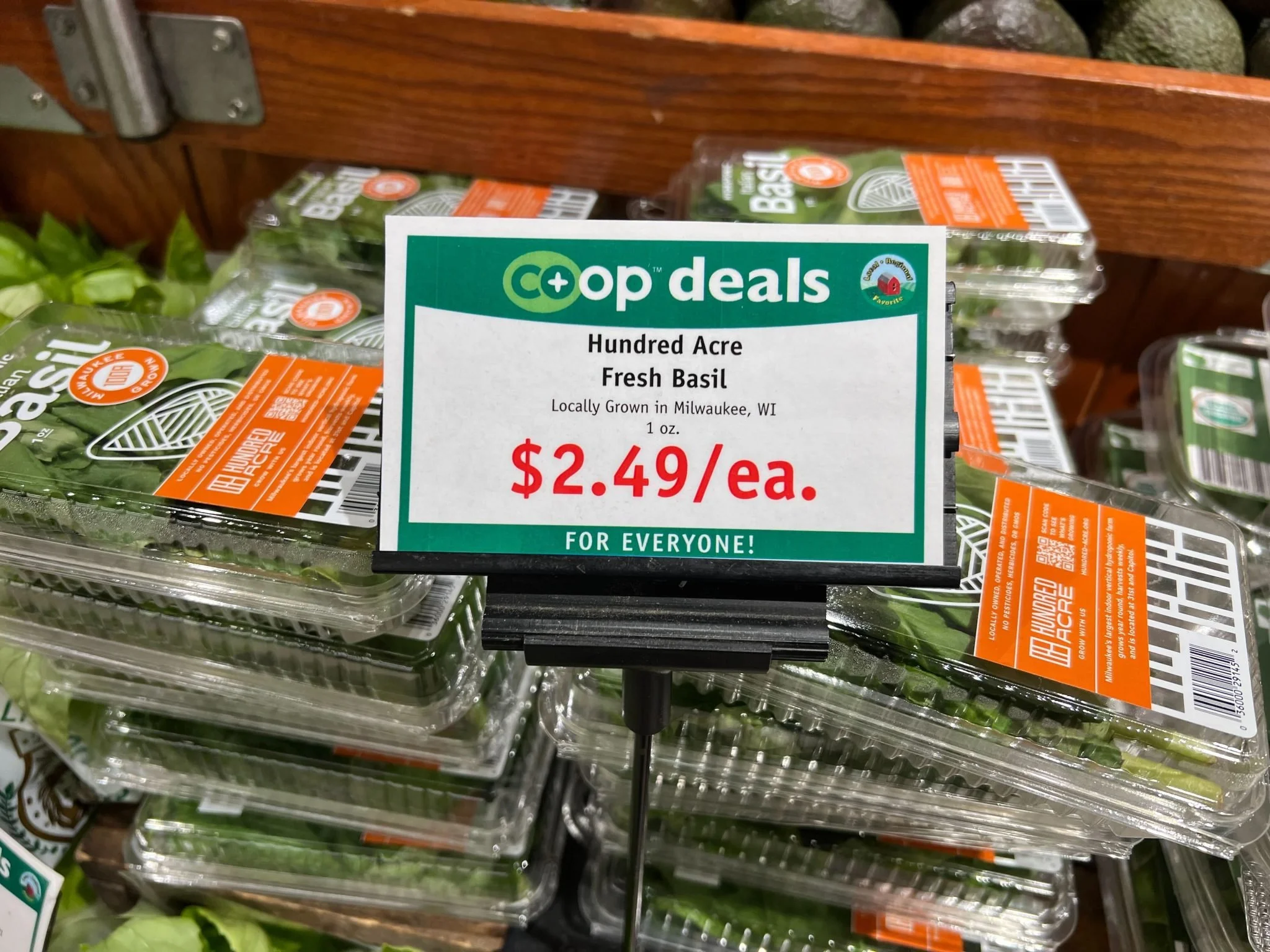 Image of Hundred Acre Basil at Outpost Natural Foods, with price sign in front 