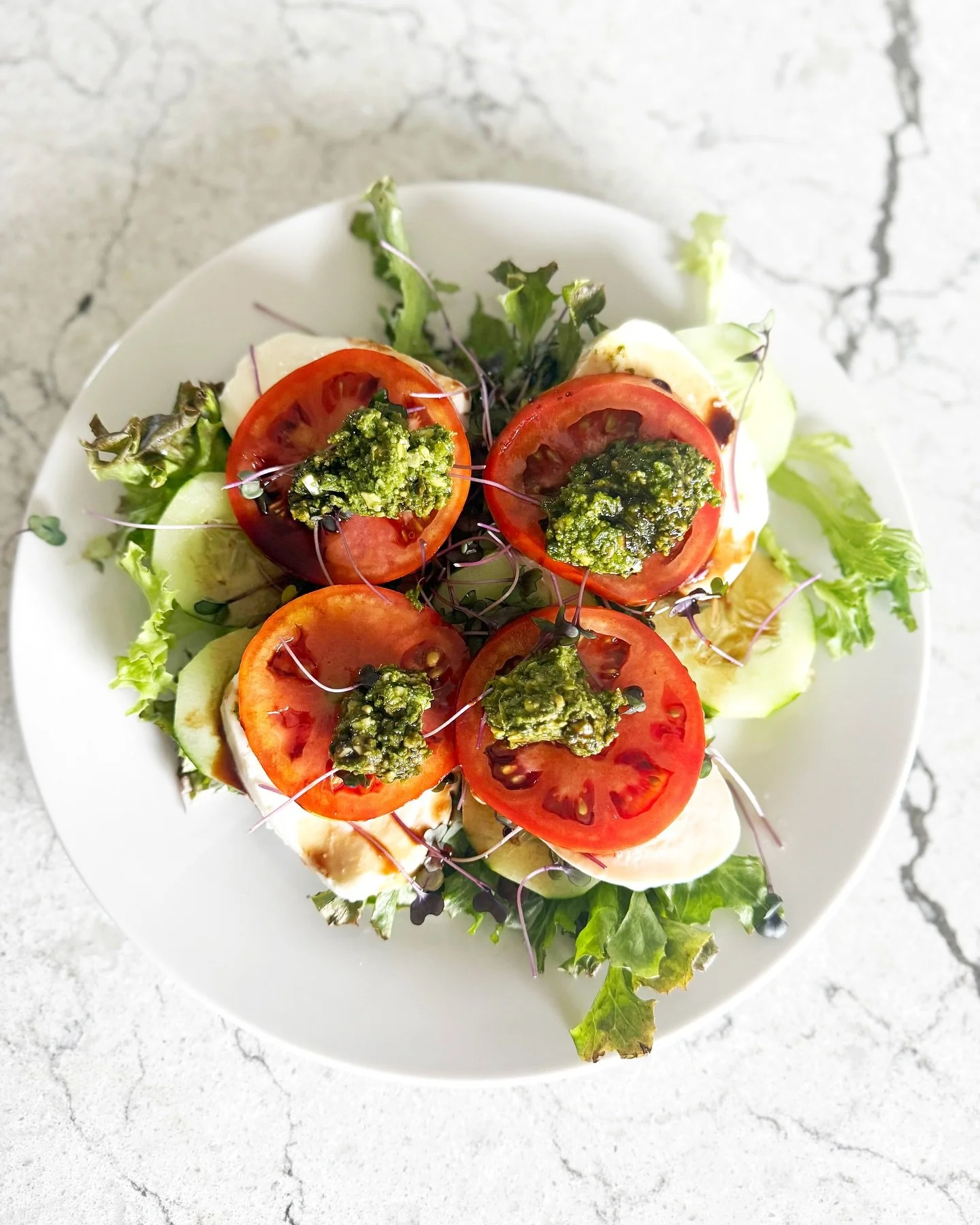 A farm-fresh twist on the classic caprese 🌱🍅 Fresh mozzarella, juicy tomatoes, our tasty pesto, and microgreens all served on a bed of our salad mix. Simple, colorful, and full of flavor&mdash;from farm to your plate!