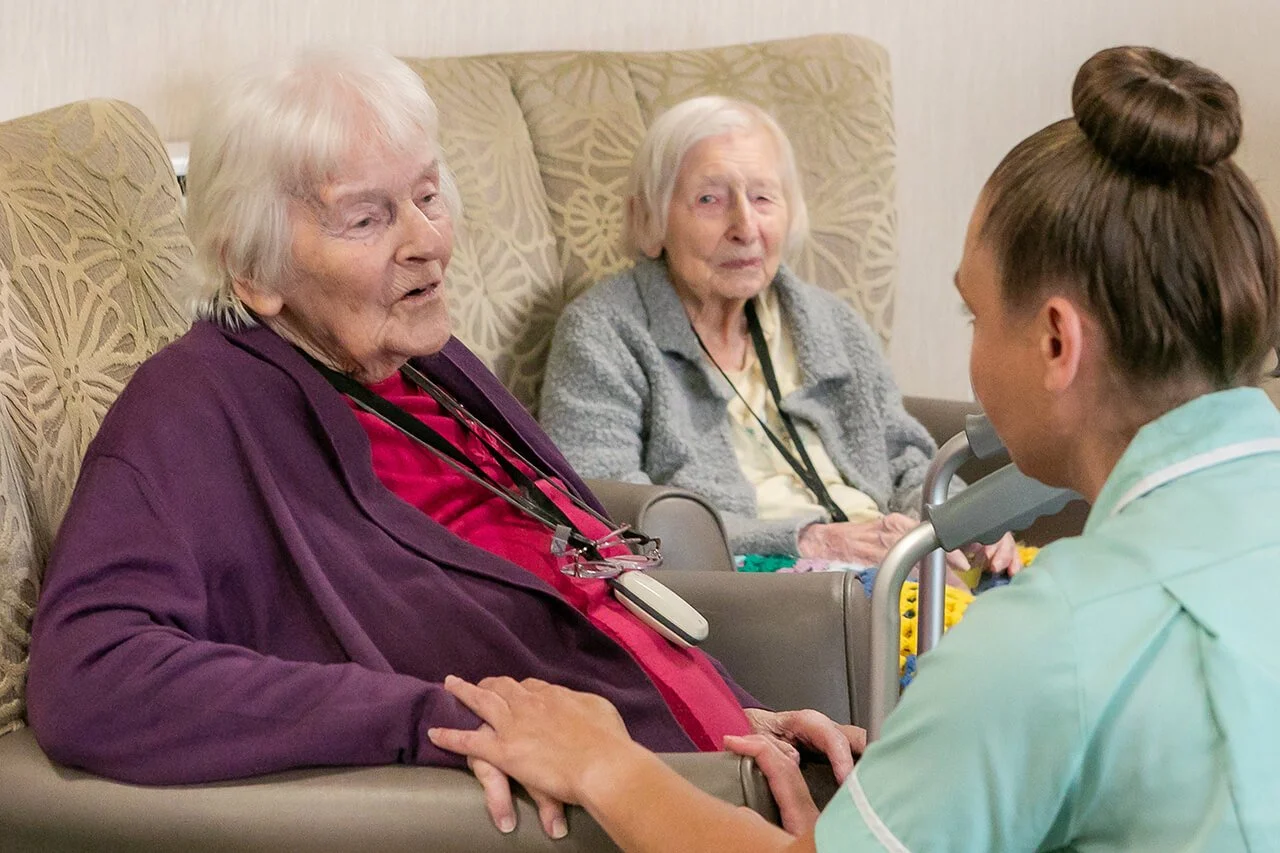 Two Dyneley residents chatting with a staff member