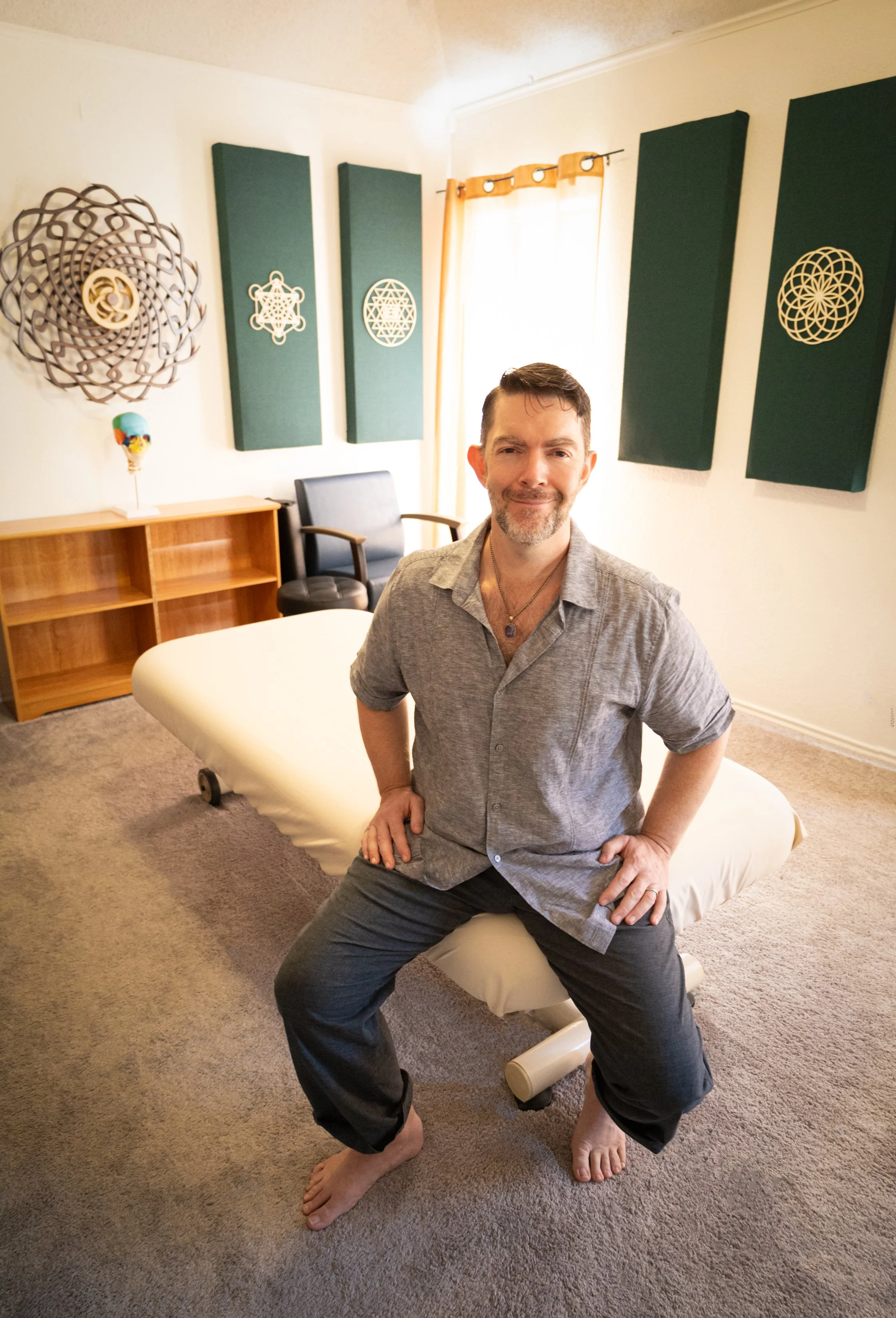 Marty sitting on the table in his treatment studio