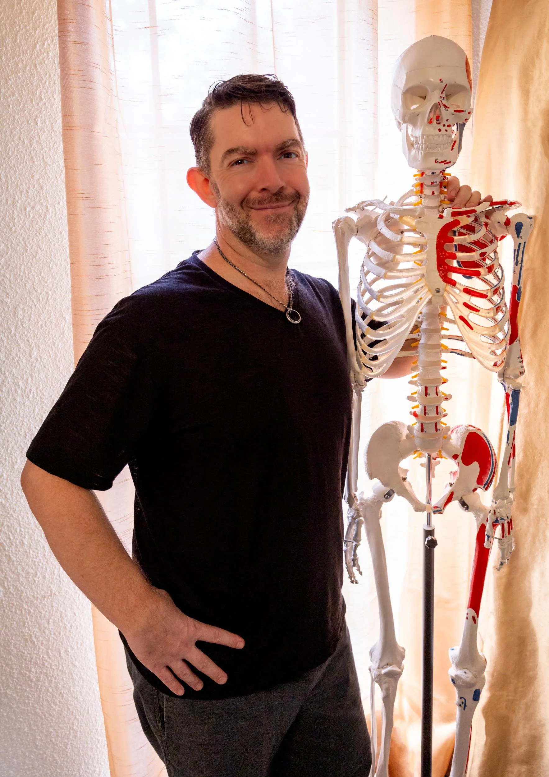 Marty standing next to a skeleton model in teacher mode