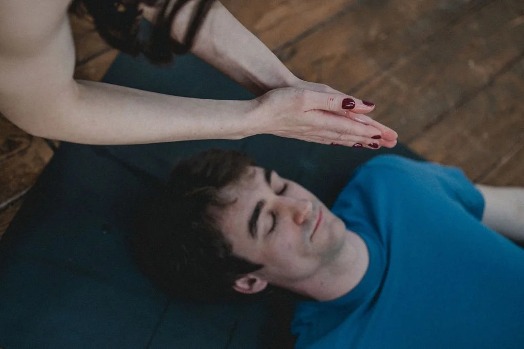 Cally Youdell assisting a student in savasana in a private yoga session, Hale Altrincham