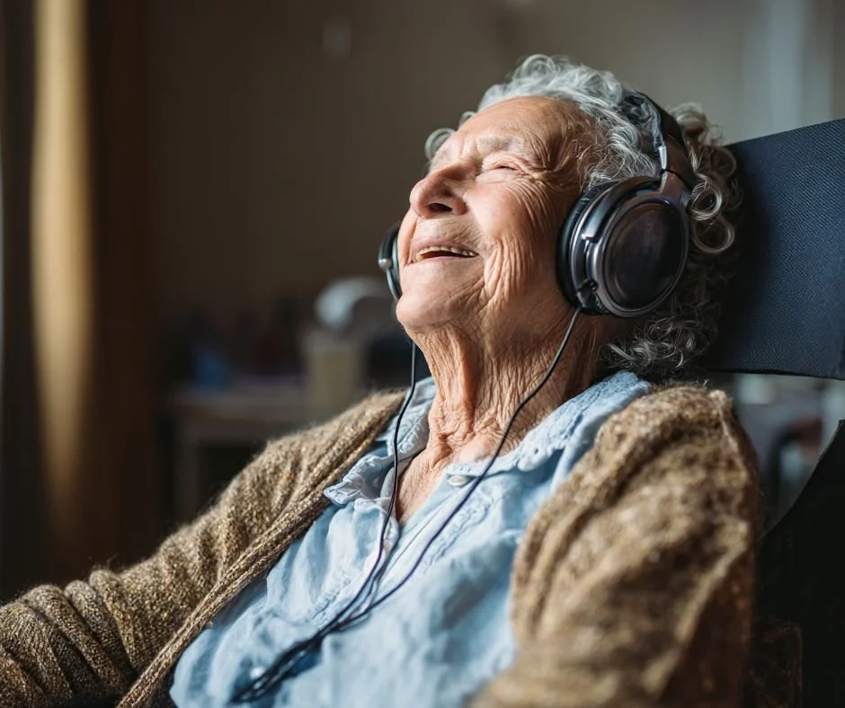 Older woman wearing headphones closing her eyes and smiling.