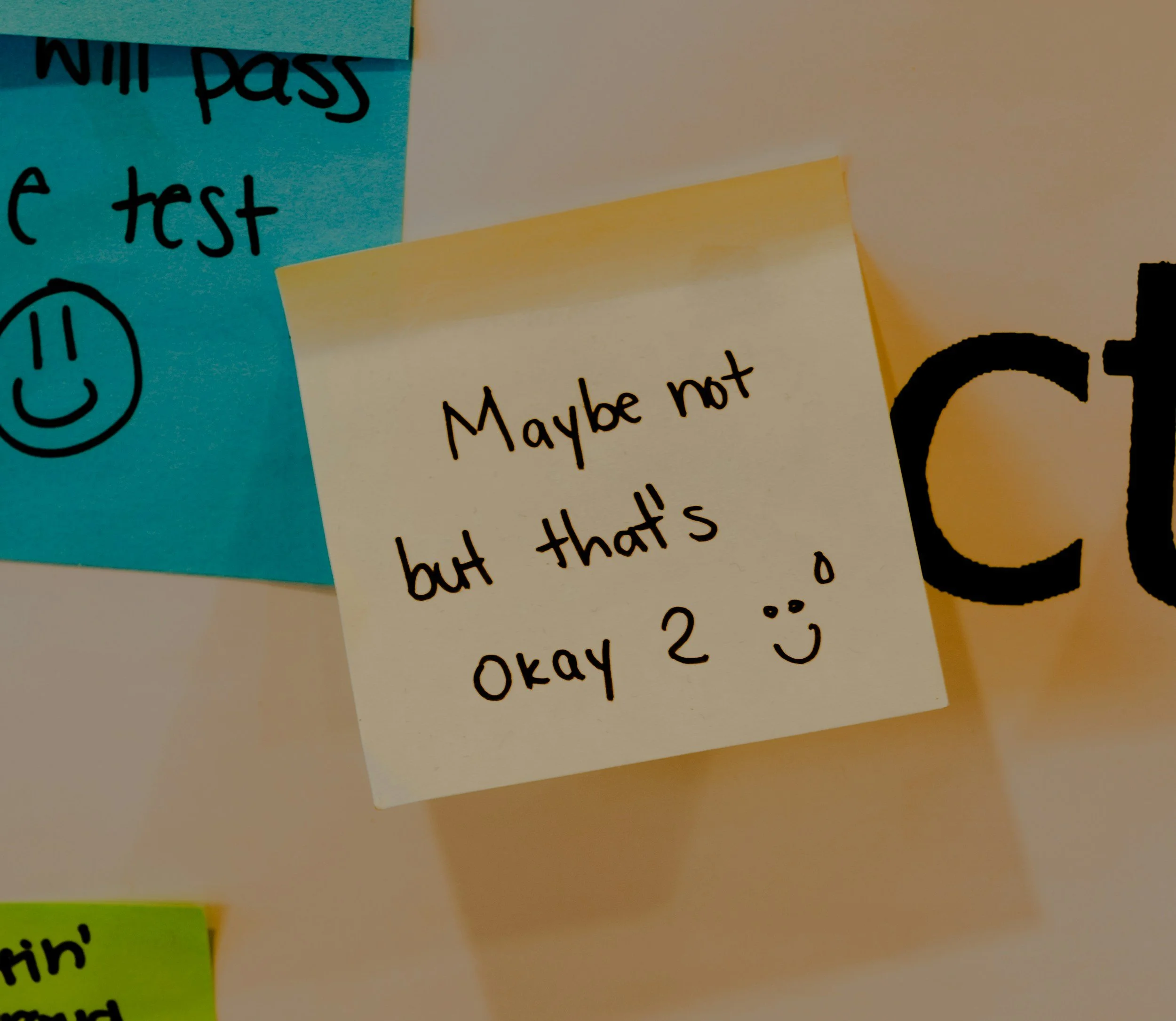 A handwritten note on a sticky note saying, 'Maybe not but that's okay :)' with a small smiley face.