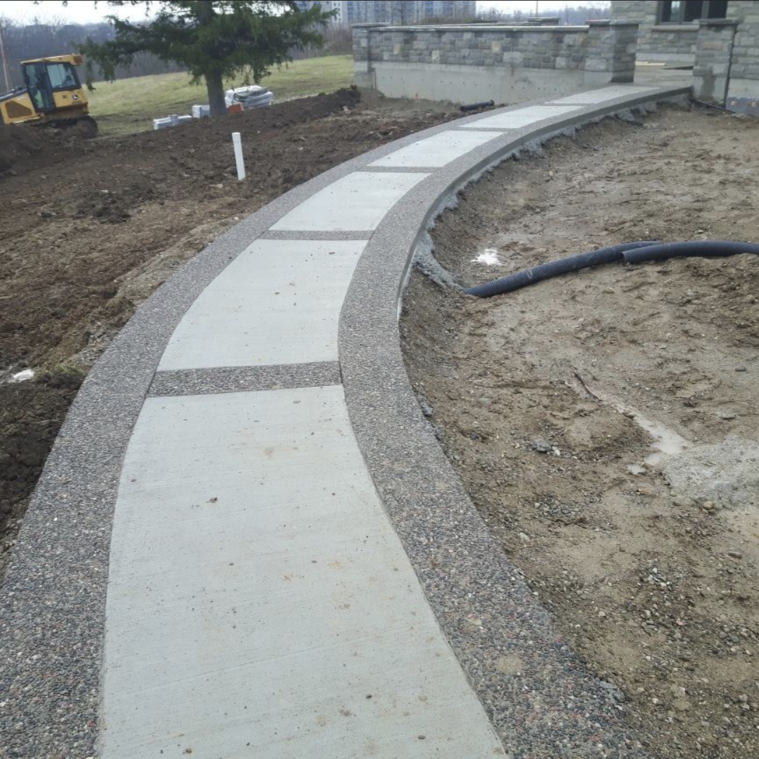 broom finish concrete sidewalk with rocky top borders.png