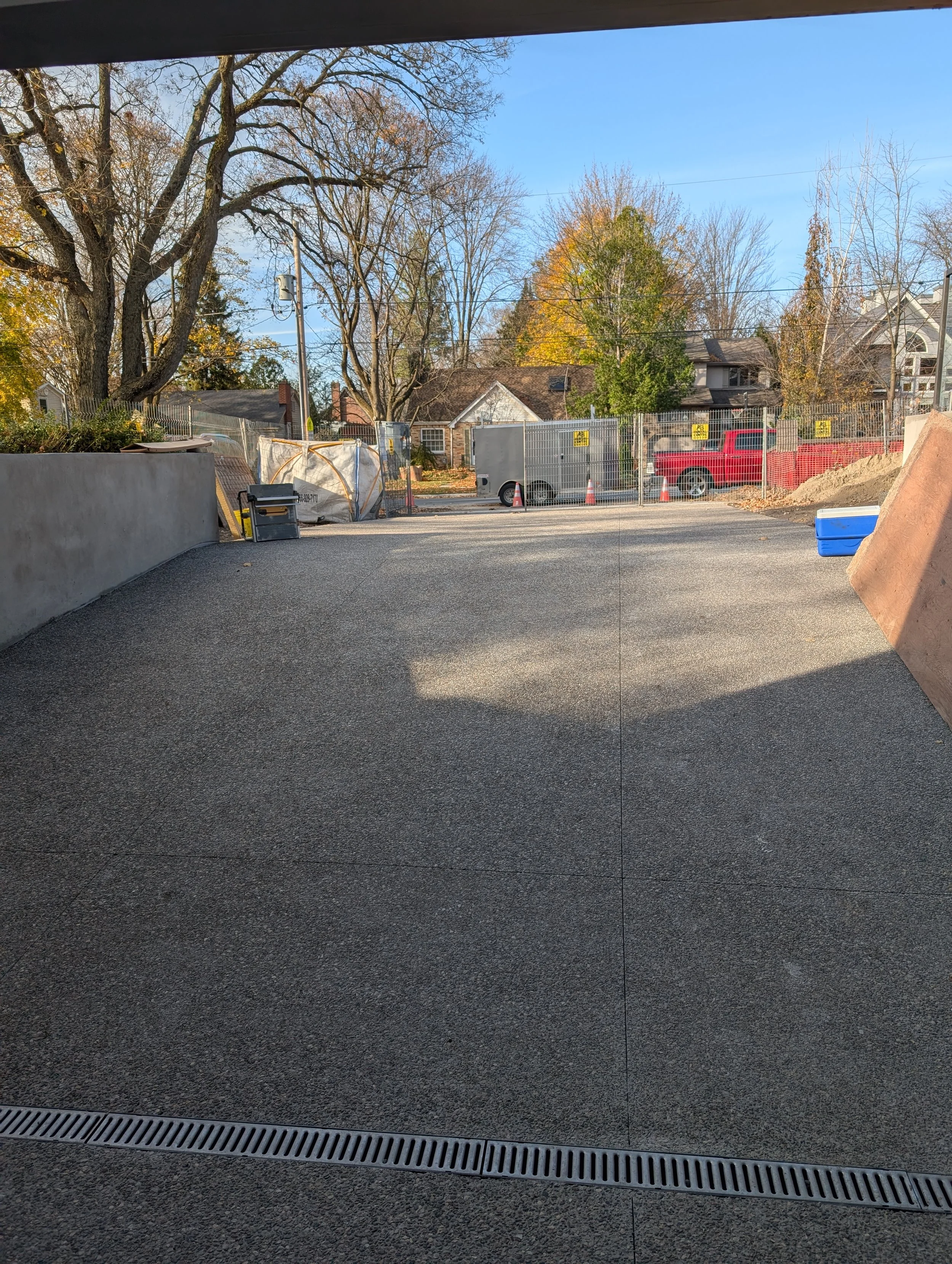 Inset drain on negative slope Brown rocky top concrete driveway.jpg