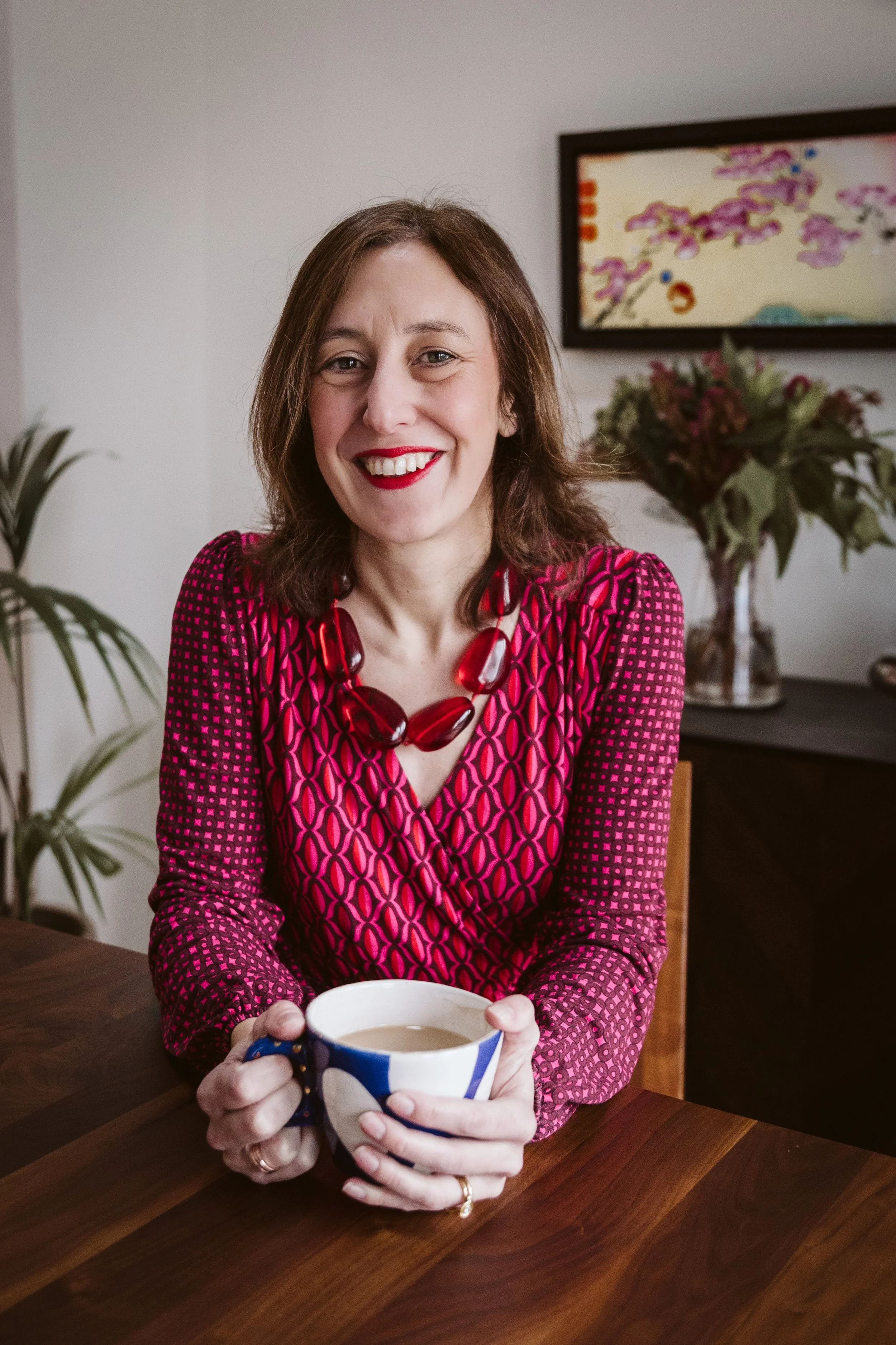 Chloe Fletcher of The Jobshare Revolution sits smiling with a cup of Yorkshire tea