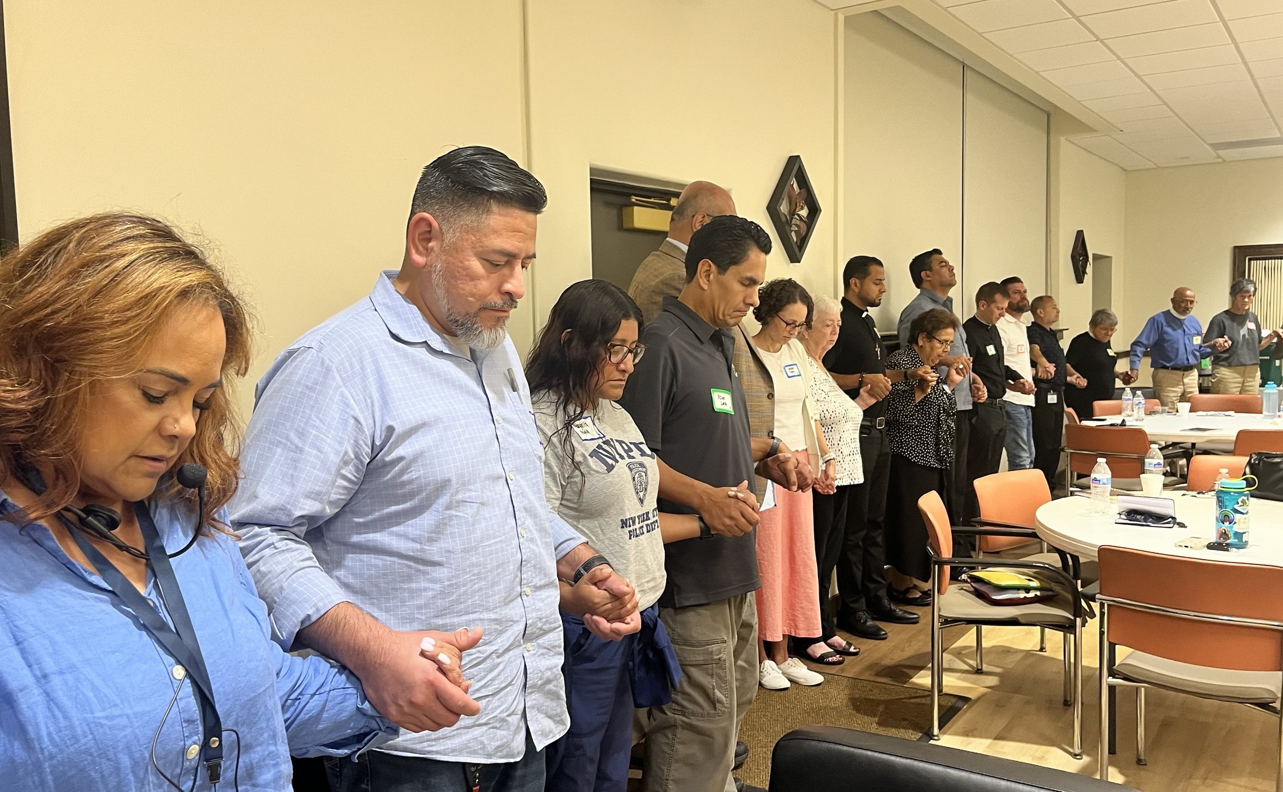 Ministers from many different faith traditions hold hands in prayer at a training by CSPL for faith leaders going into the Broadview detention facility