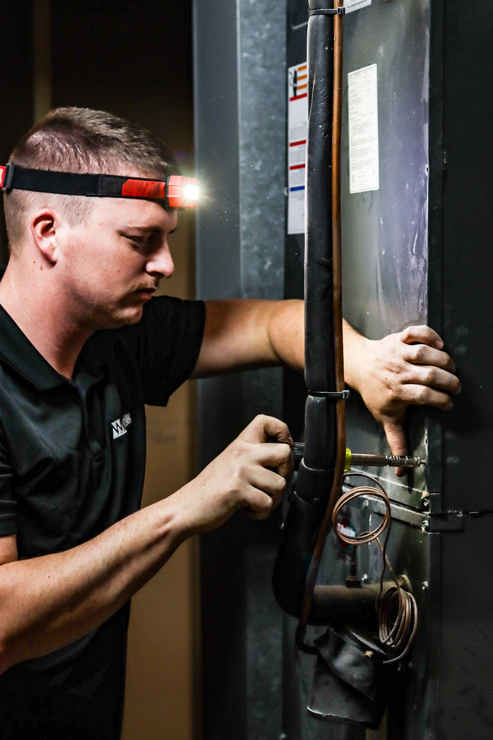 Wooldridge HVAC Technician doing routine maintenance