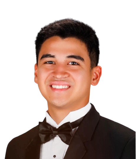 A young man in a tuxedo with a bow tie, smiling against a black background.