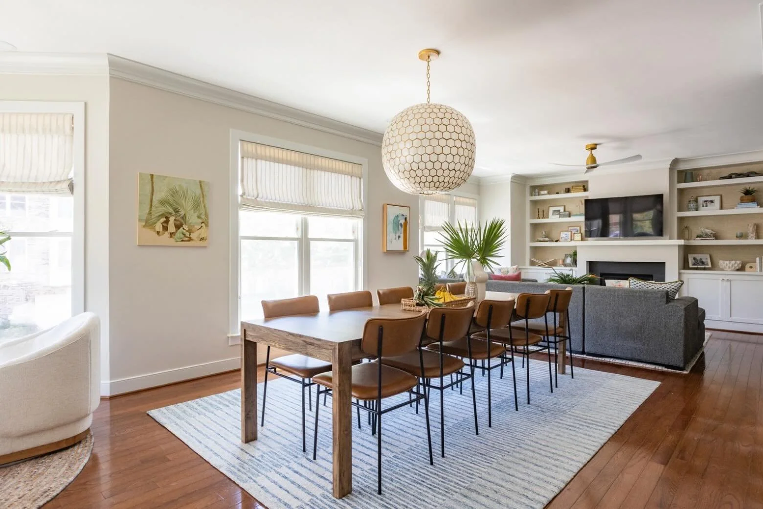 Not everything needs to be new to make a space feel completely refreshed.

Our clients already had this Room &amp; Board dining table and the statement light fixture, so we kept both and worked from there. The table got a new life with a darker stain