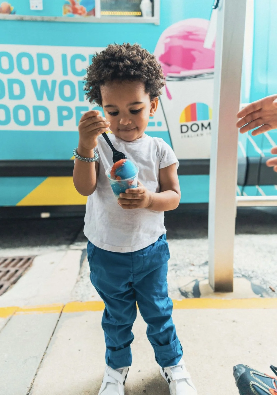 Toddler enjoying blueberry Italian ice