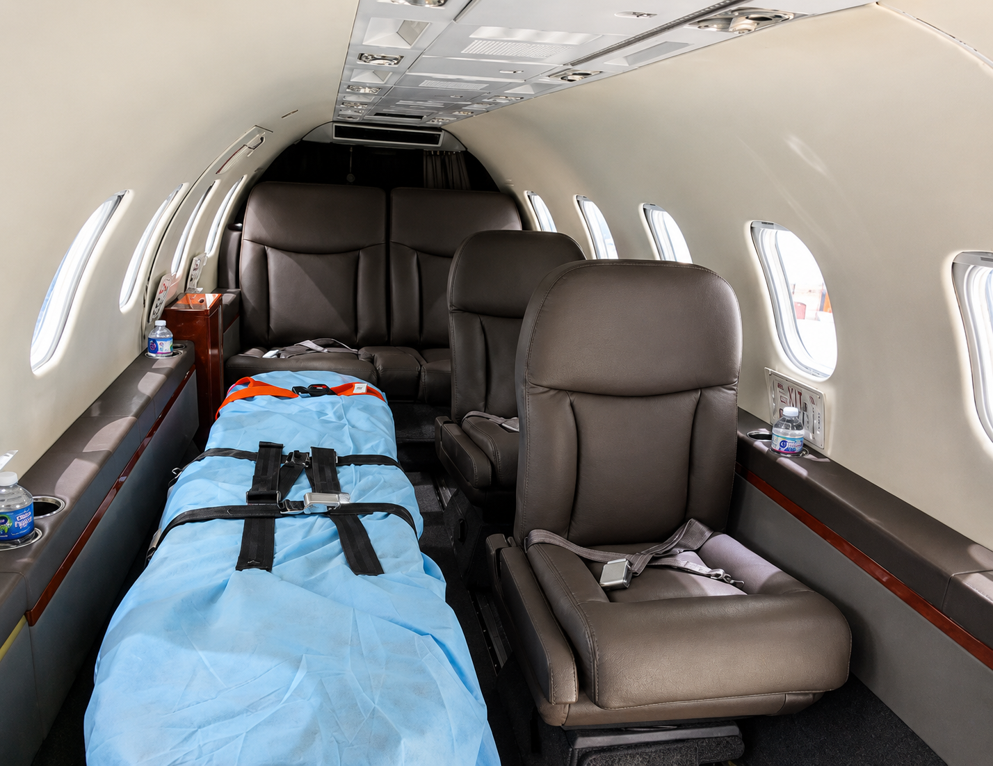 Empty airplane cabin with a stretcher and seats inside a private jet.