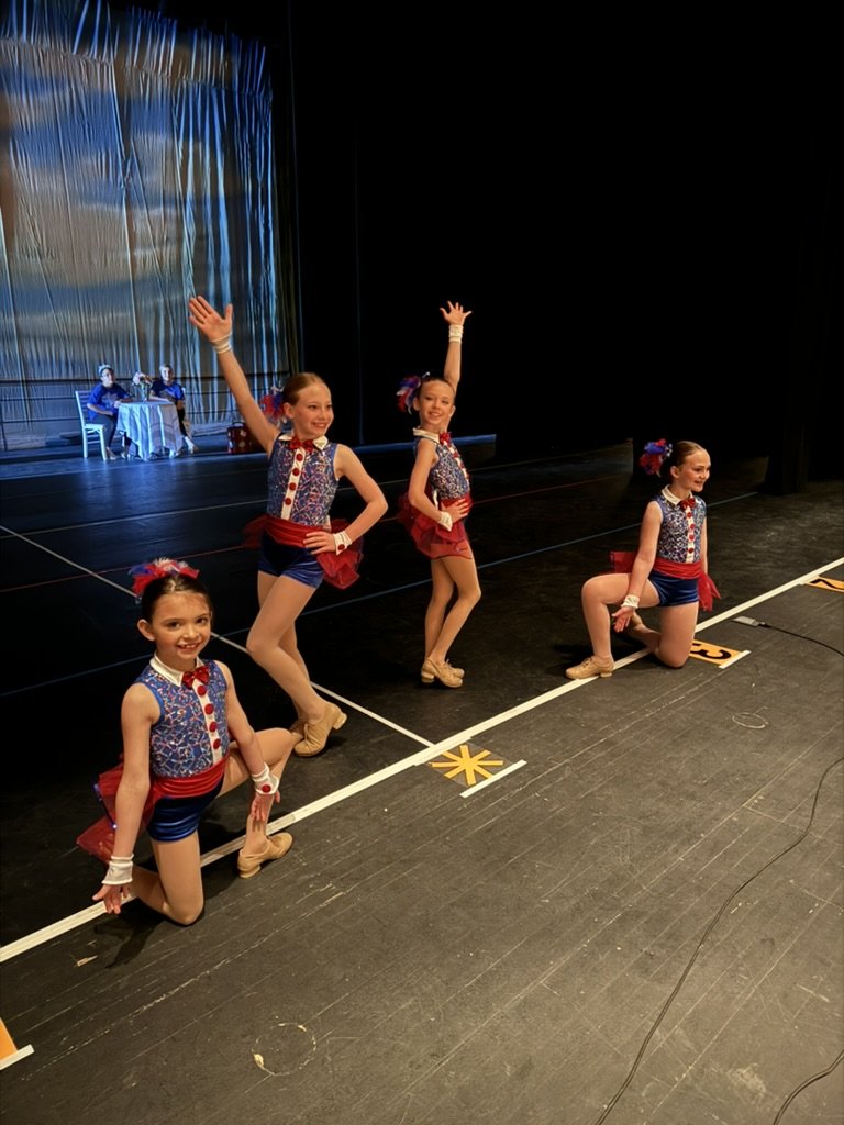 four young jazz dancers hitting their final pose