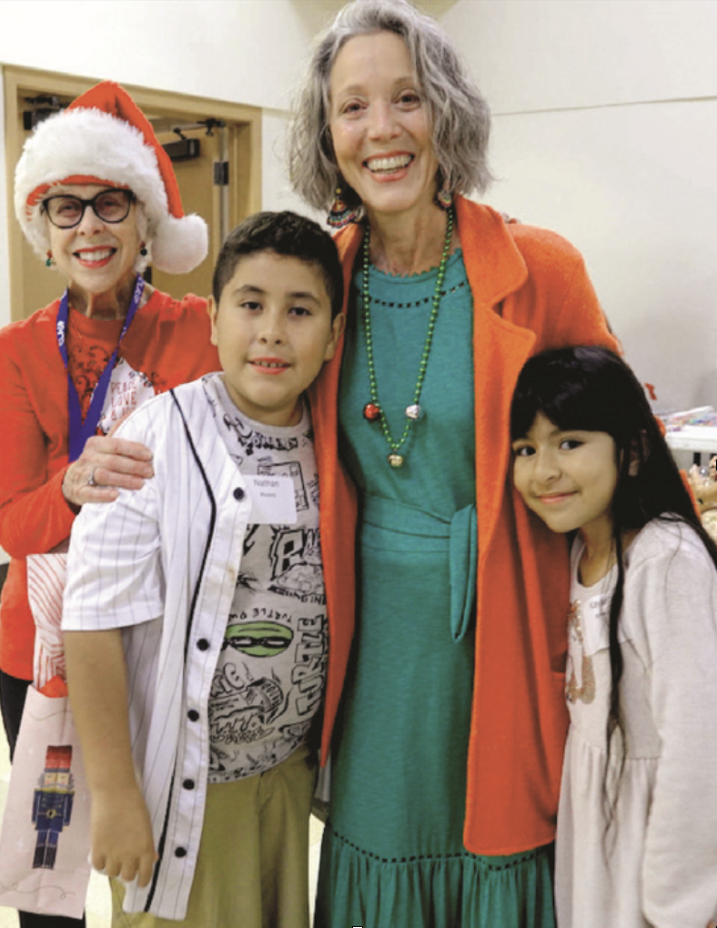 2 adults and 2 children posed smiling