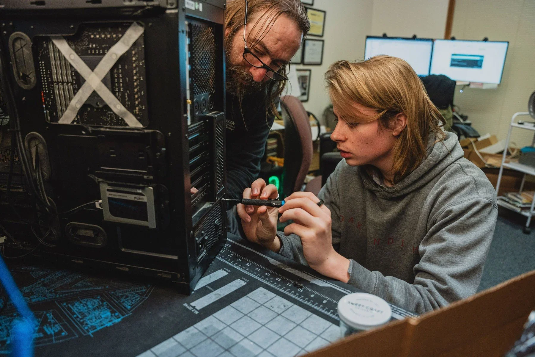 A student and mentor examining computer components · Magnolia programs