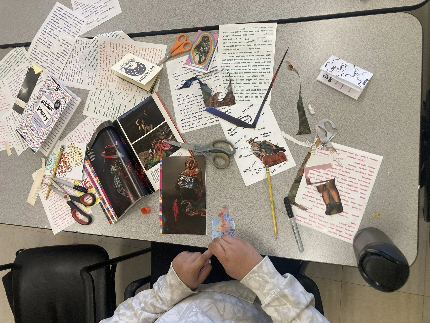 A student planning a creative project with paper and drawings · Magnolia programs