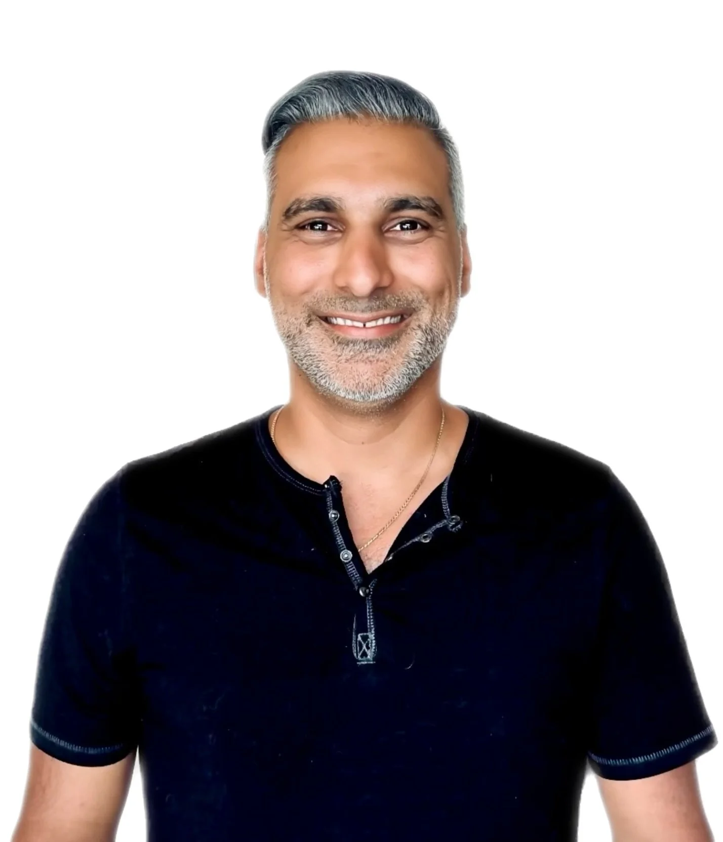 A middle-aged man with short gray hair, a trimmed beard, and a friendly smile, wearing a black shirt and a gold necklace, standing against a plain white background.