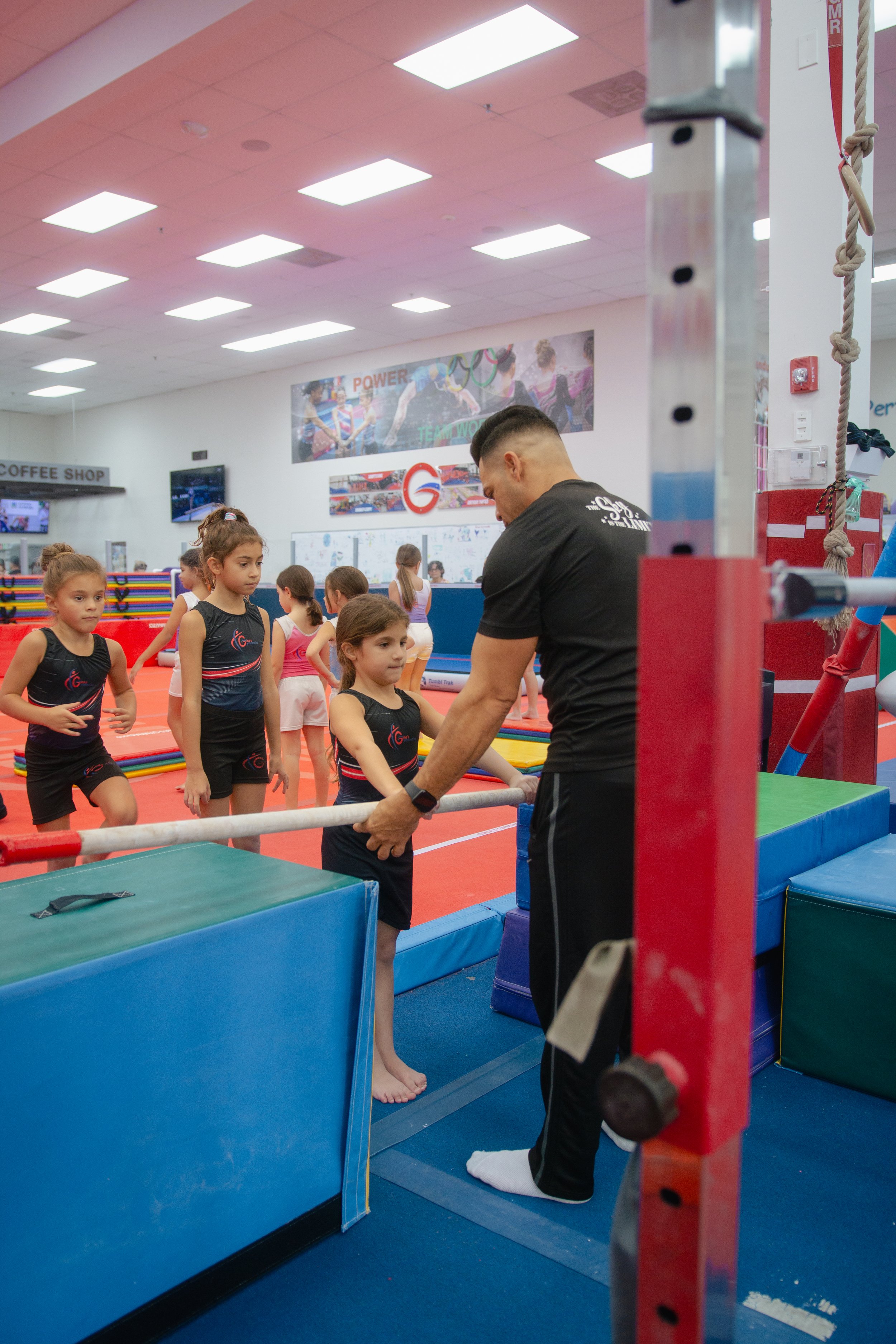 gymnastics coach training a young girl at ginas gymnastics