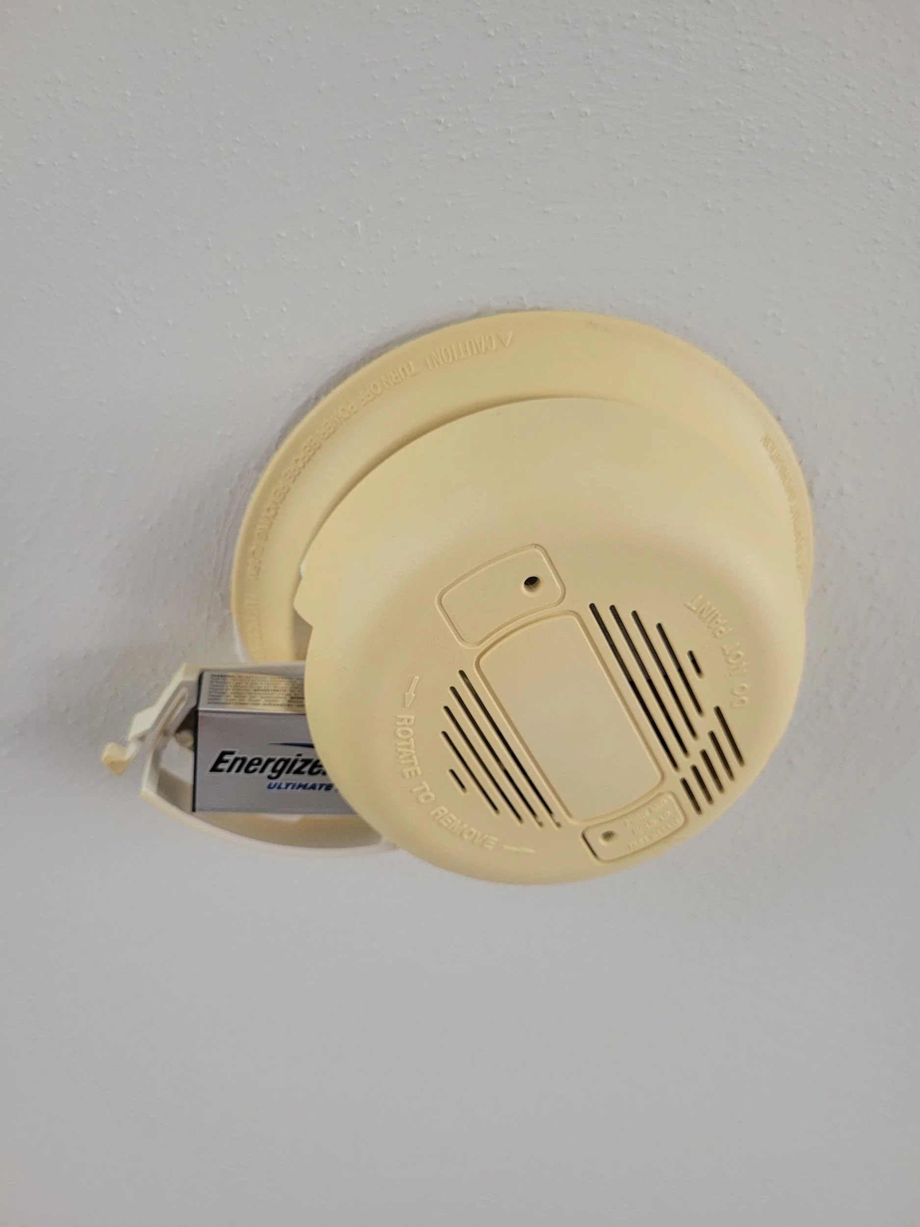 old smoke alarm needing battery replacement