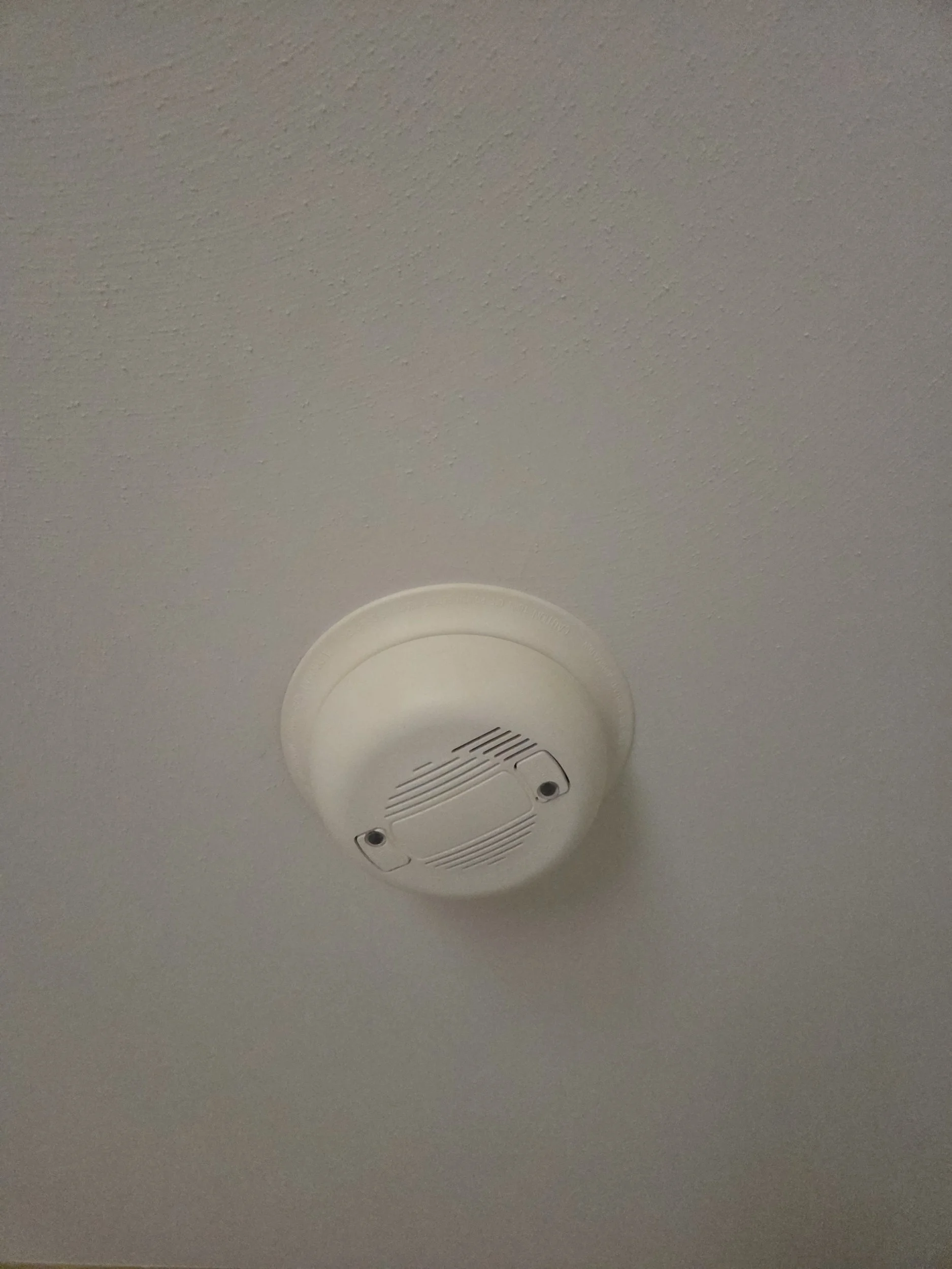 Photo of old smoke alarm needing to be replaced