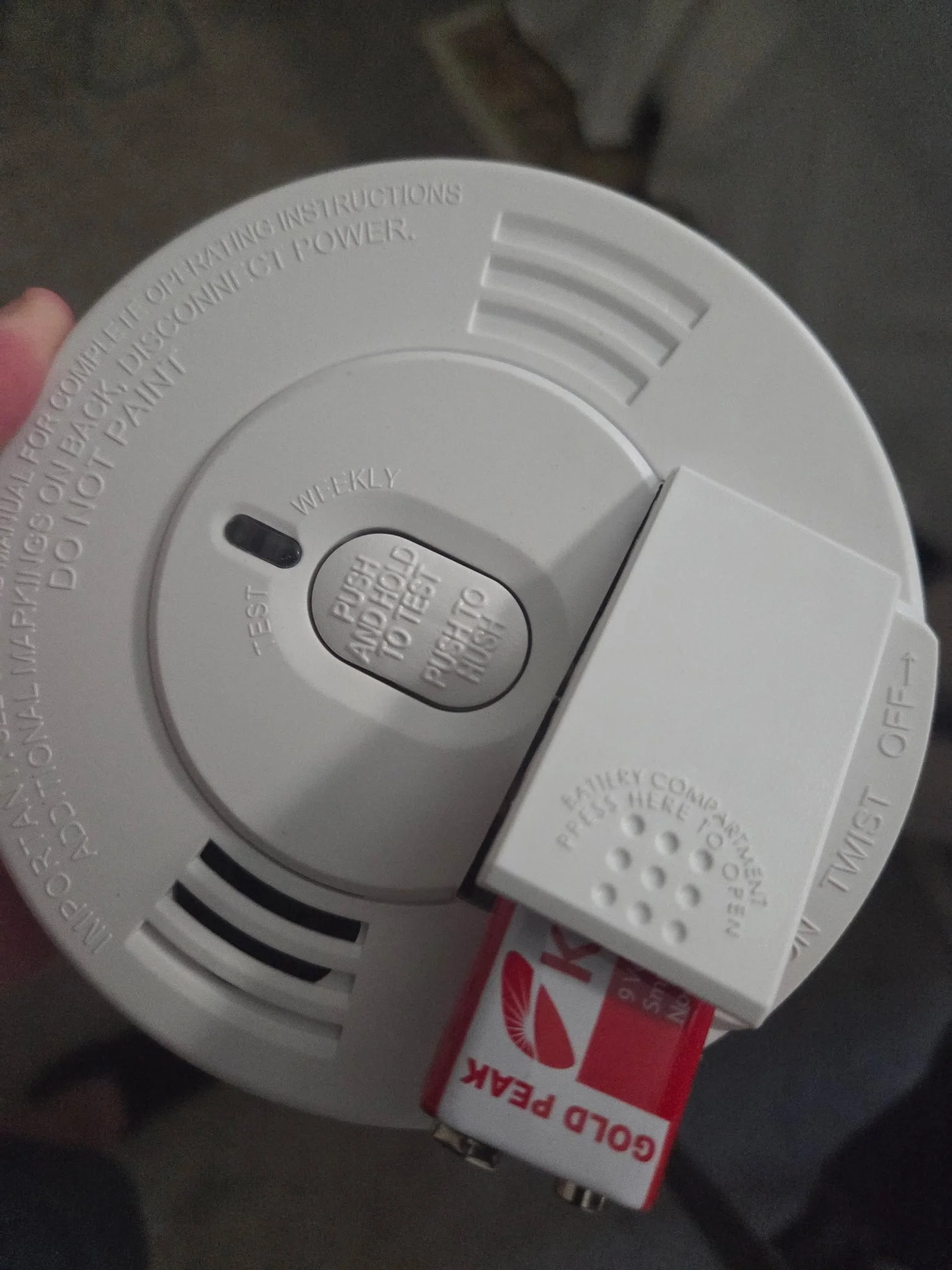 resh battery being installed in a smoke alarm
