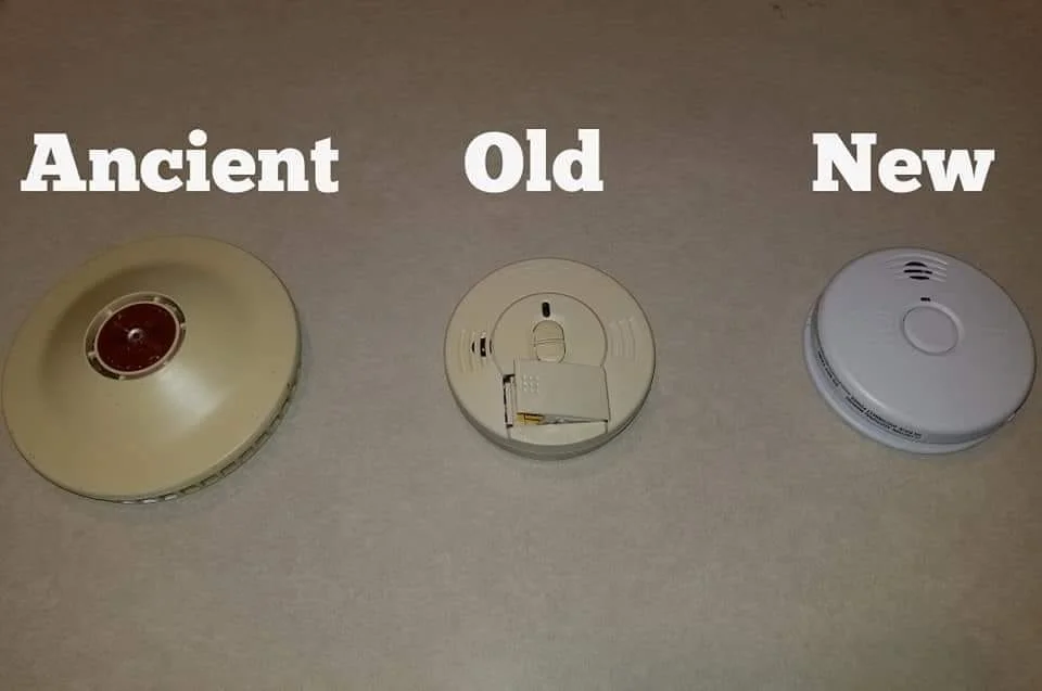 Three smoke detectors labeled as 'Ancient,' 'Old,' and 'New' to show the evolution of design and when to replace them.
