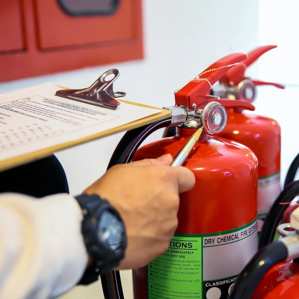 Smoke Detector Pro servicing a Fire extinguisher